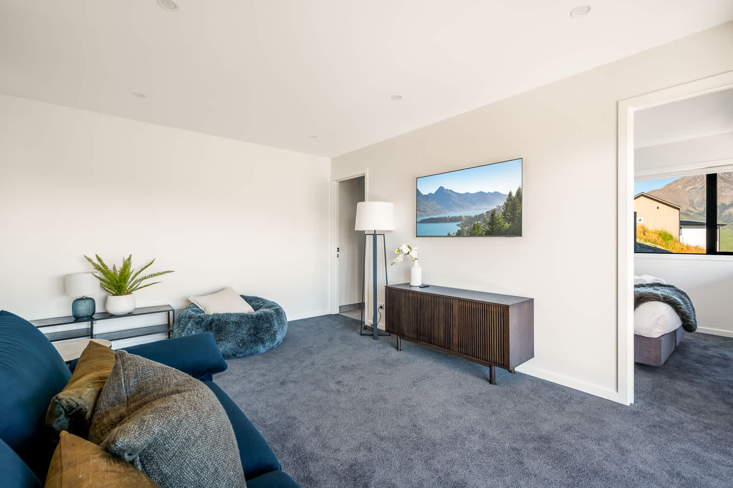 The living room is thoughtfully designed with comfortable seating, perfect for enjoying a quiet evening with family and friends.