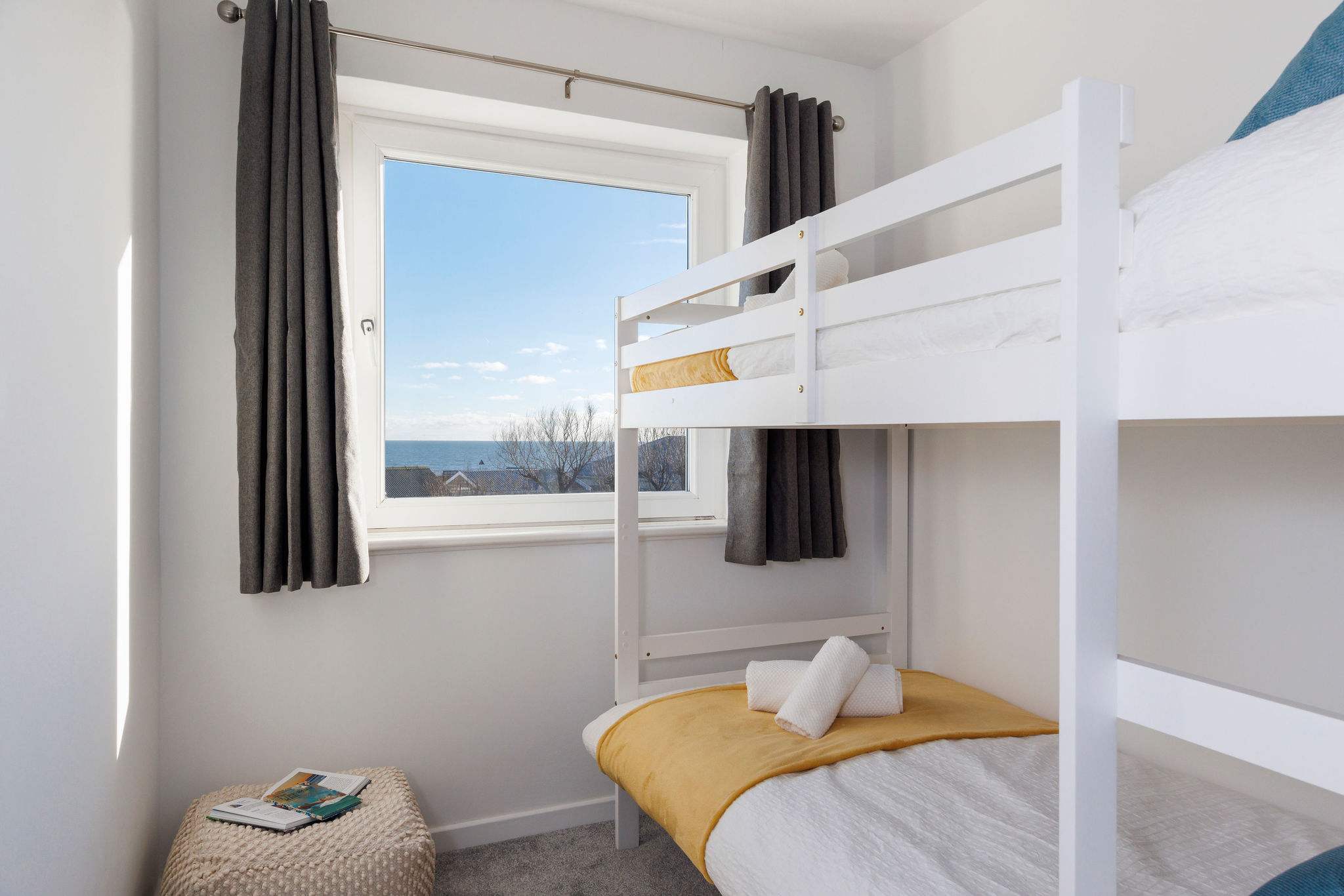Cozy bunk room with a stunning sea view