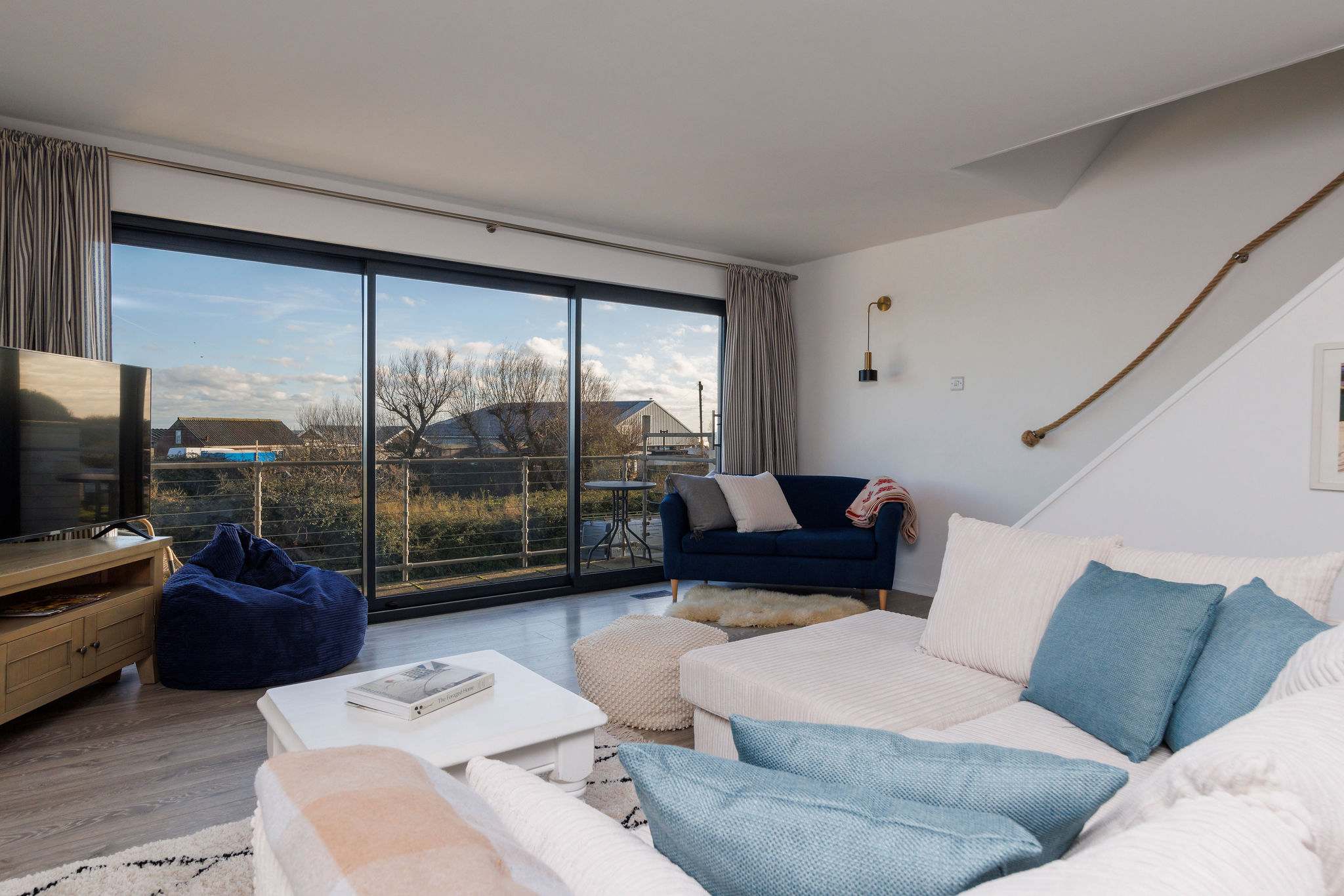 Living room opens to a balcony with peaceful outdoor views