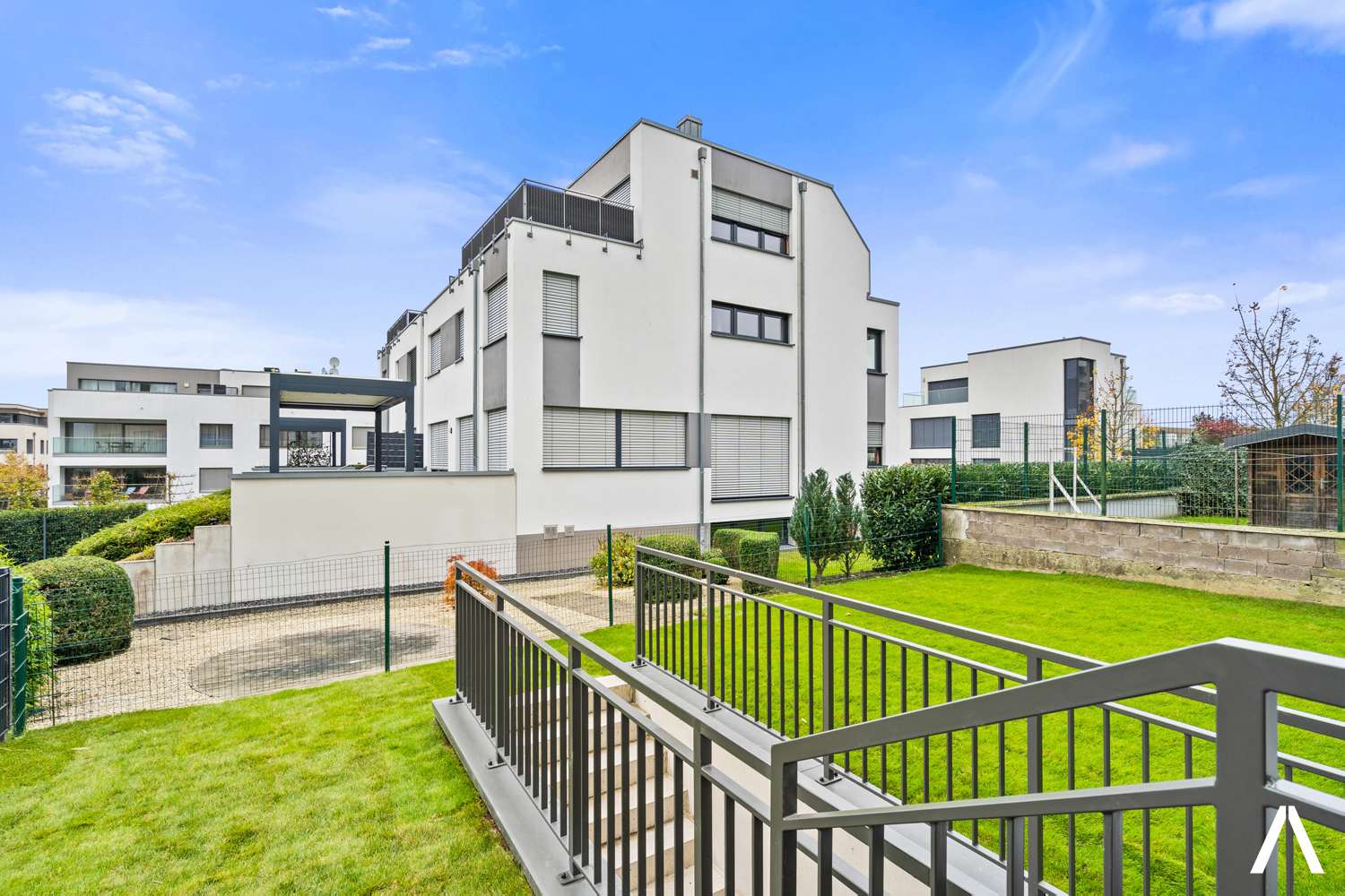 Stylish Building Exterior and Garden – A modern coliving building surrounded by greenery for a peaceful ambiance.