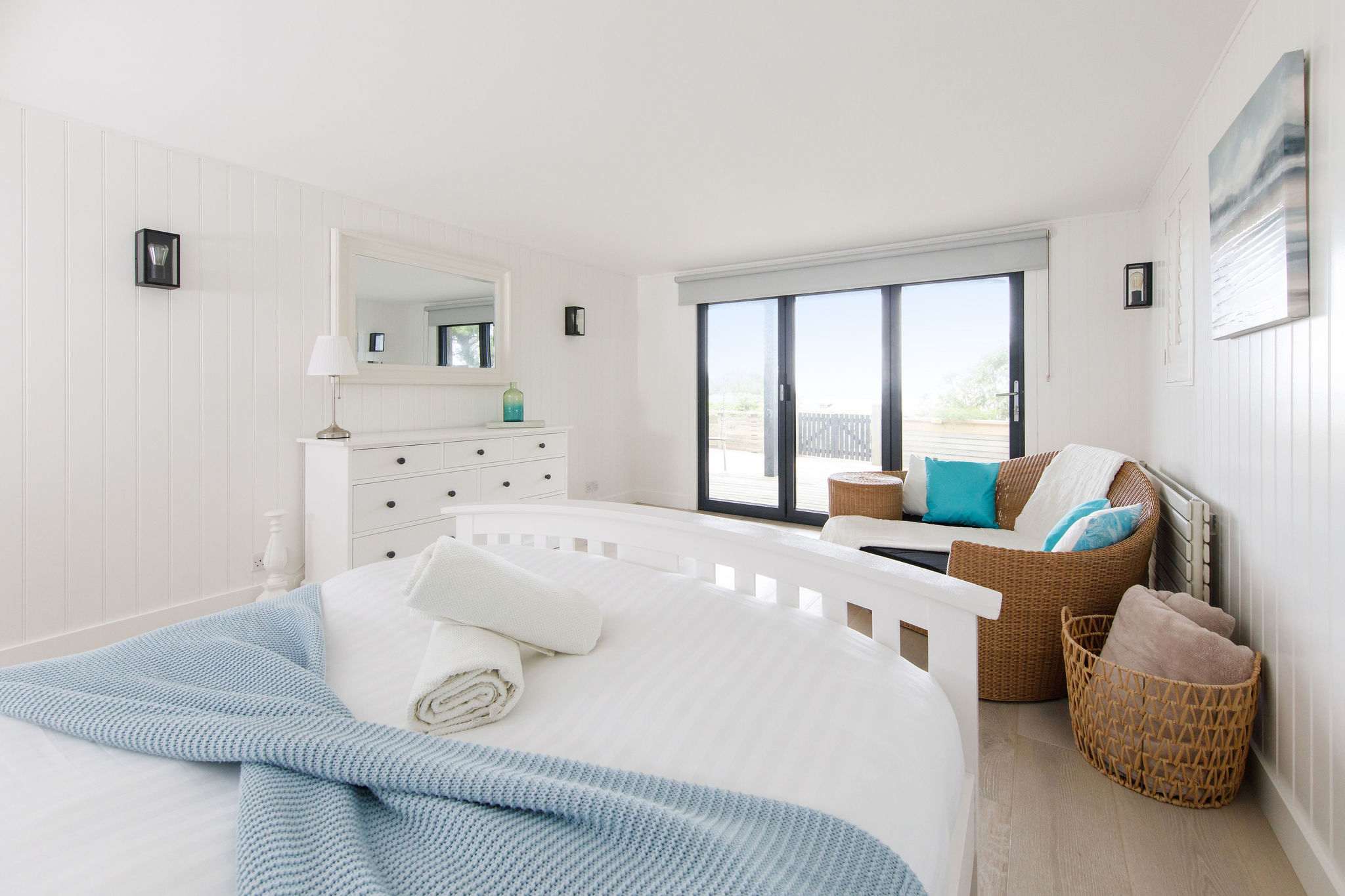 The bifold doors open up to the private garden with access to the beach.