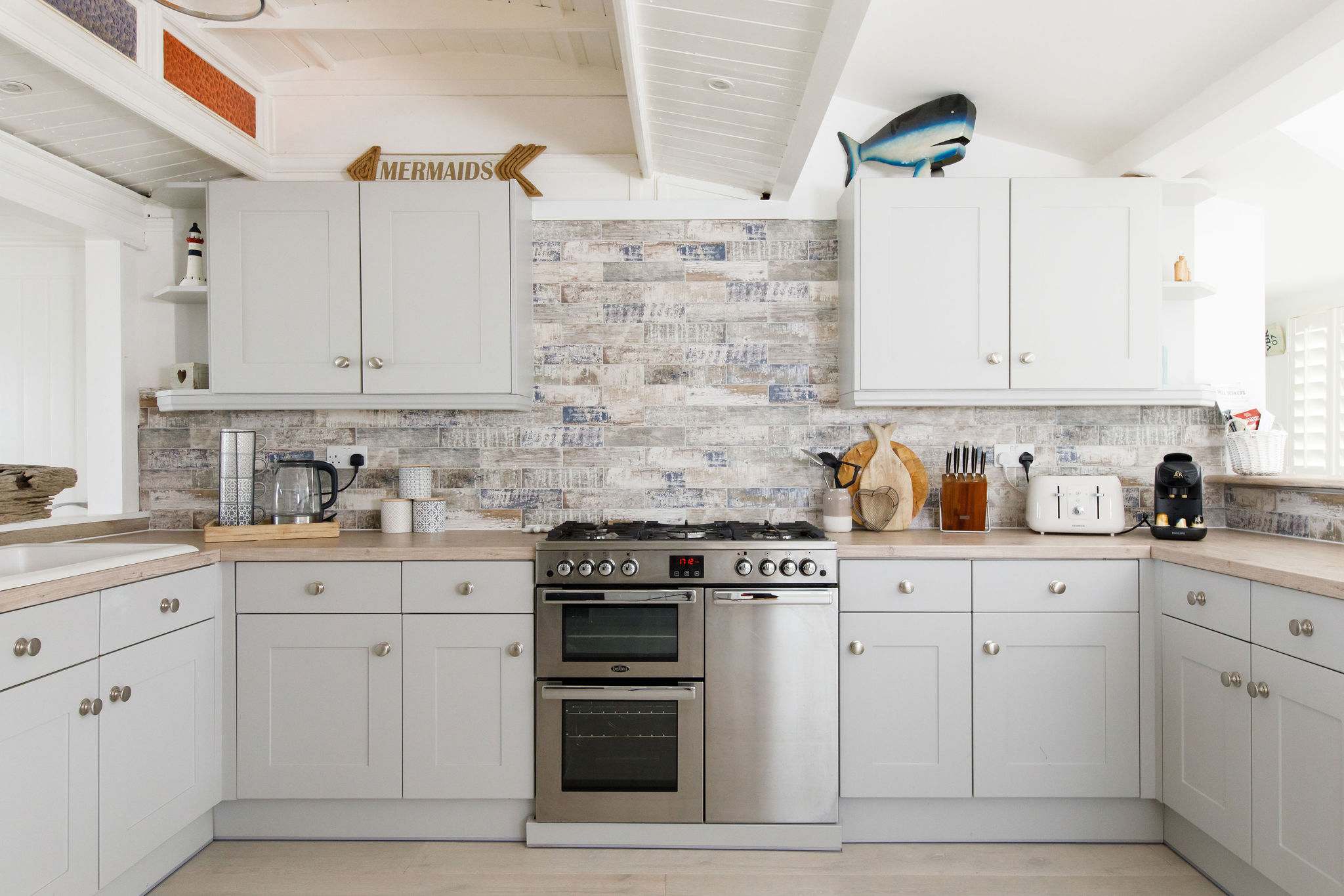 There is a Nespresso coffee machine, kettle, toaster, double oven, dishwasher and hob.