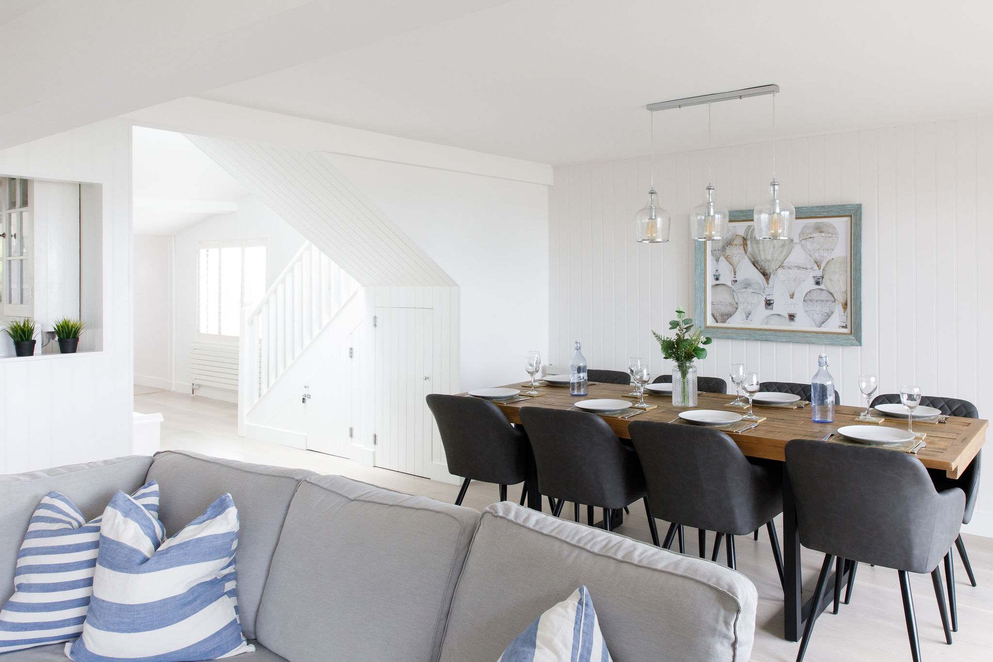 Dining table has dropdown lighting.