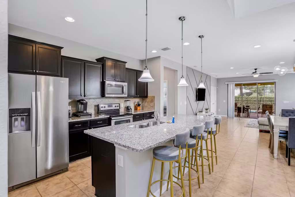 Large kitchen equipped with stainless steel appliances and everything you might need to make a delicious meal.