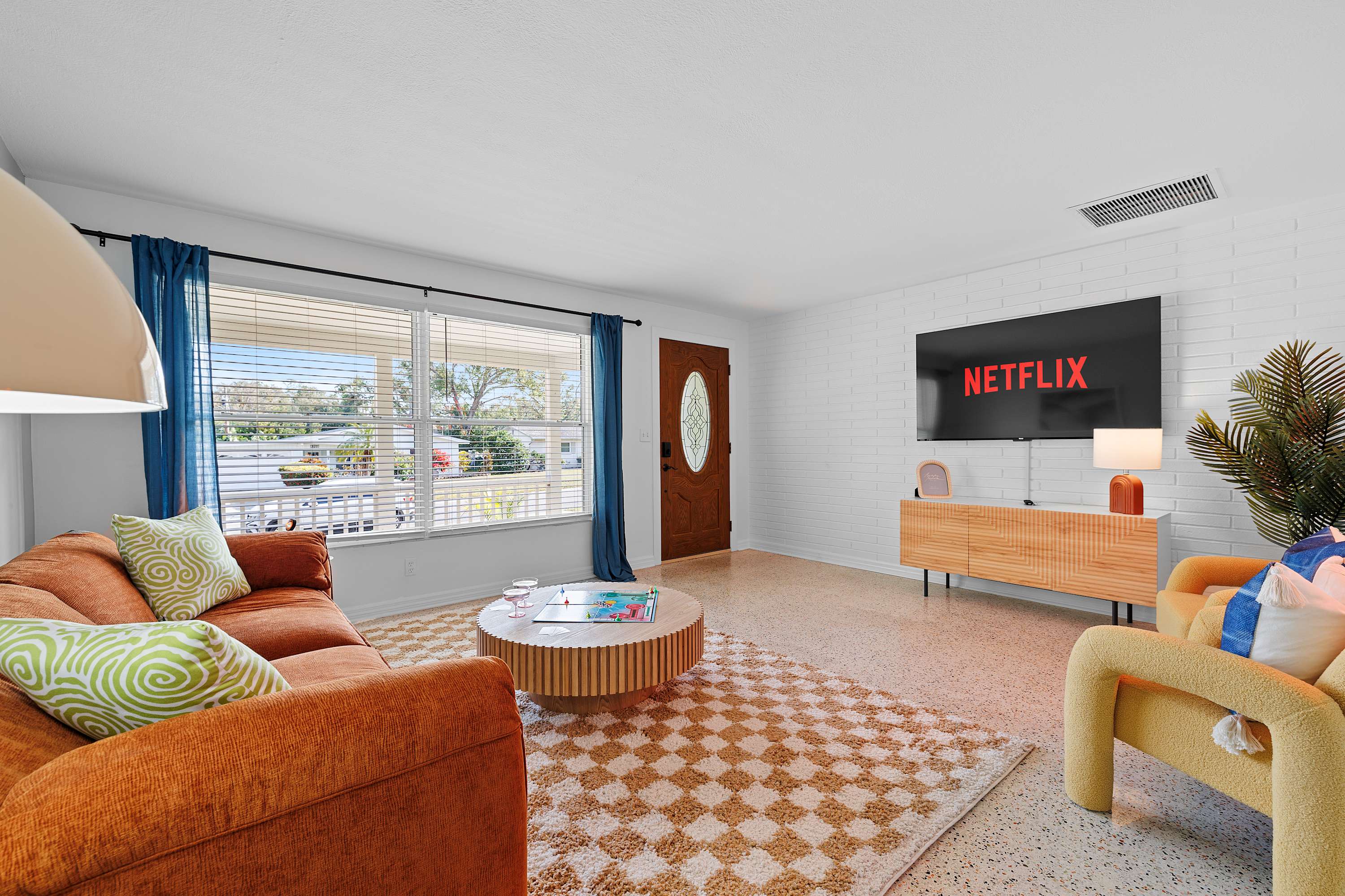 Bright living room w/ comfy seating and open flow for relaxing or gathering.