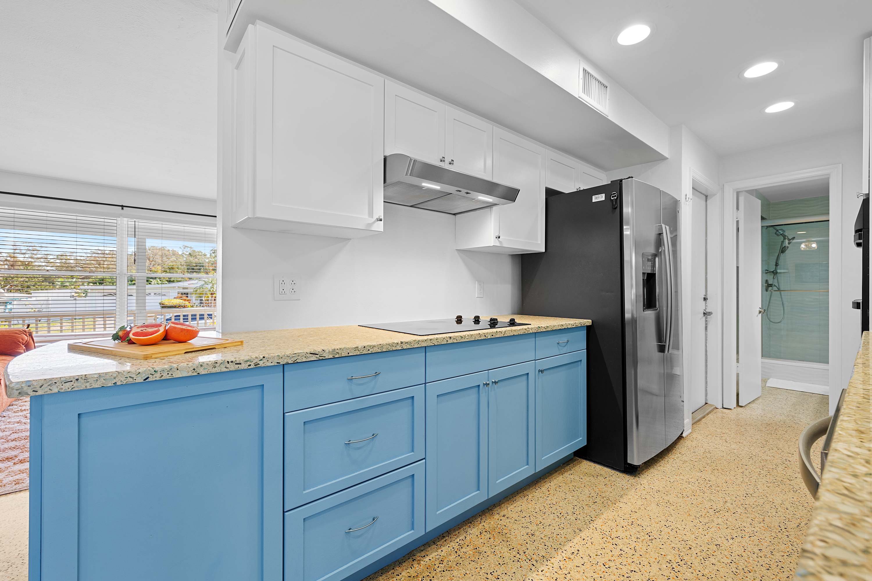 Spacious kitchen w/ blue cabinetry and plenty of prep space.