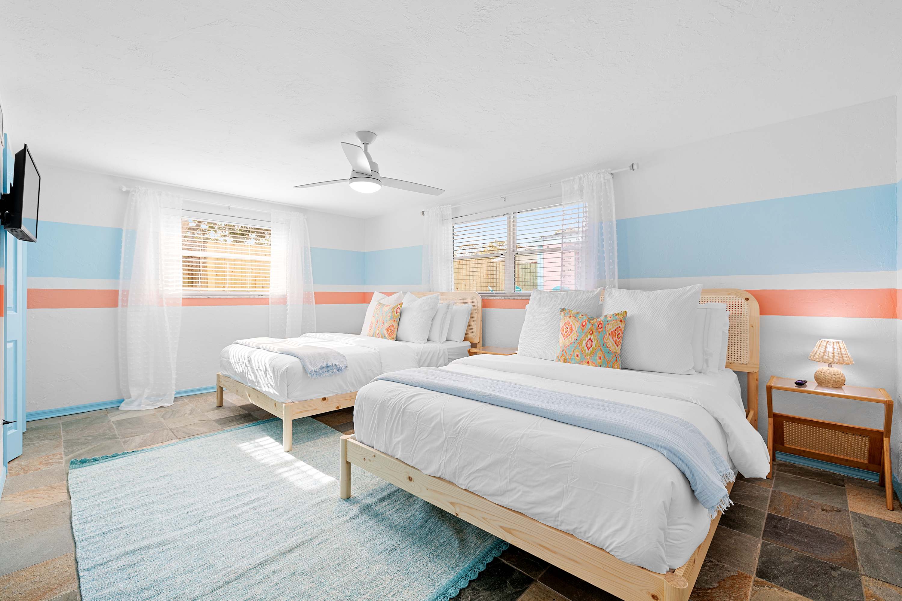 Bright bedroom w/ simple styling and a calm, comfortable feel.