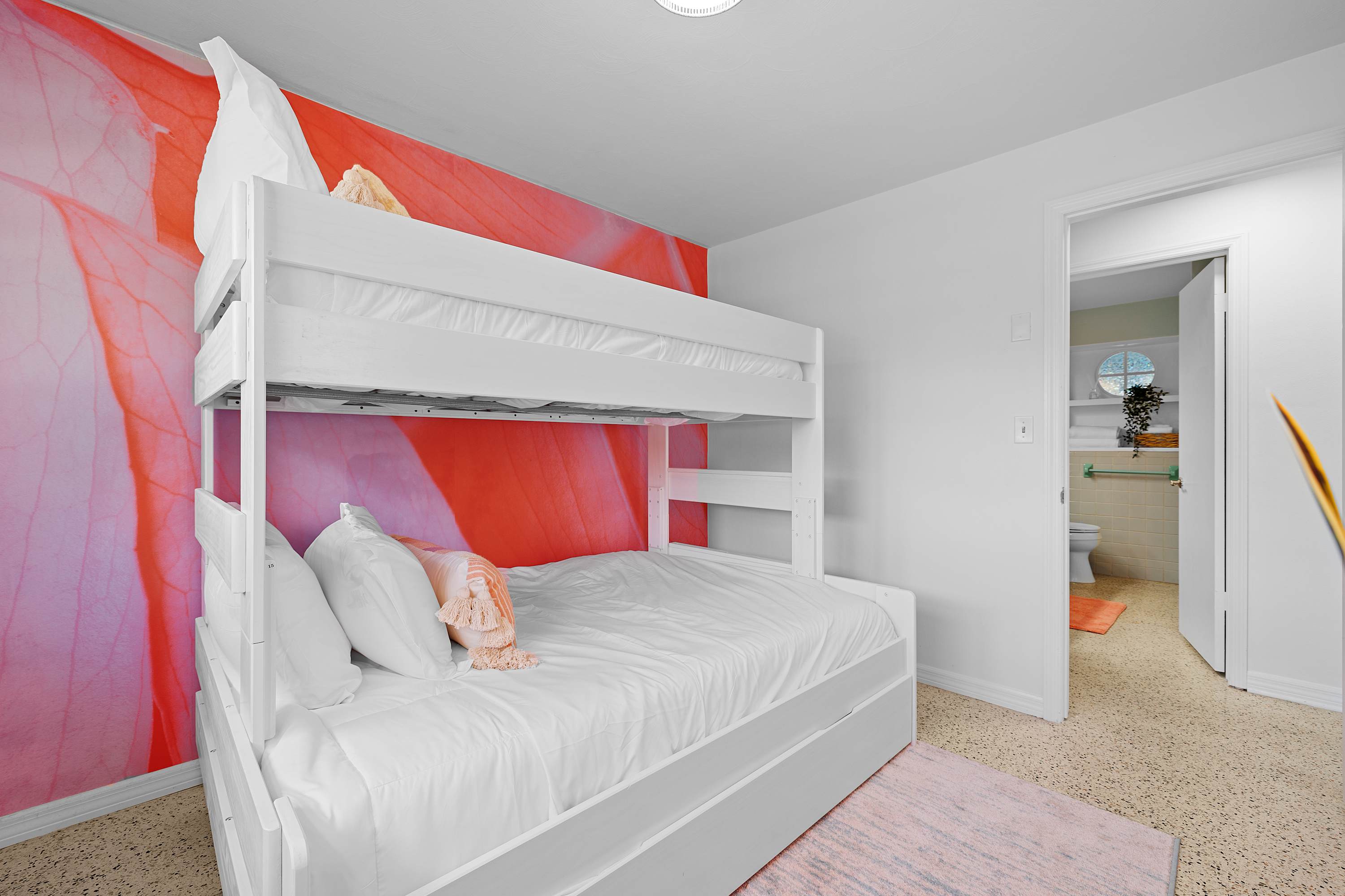 Playful bunk bedroom w/ bold colors, perfect for a fun and cozy stay.