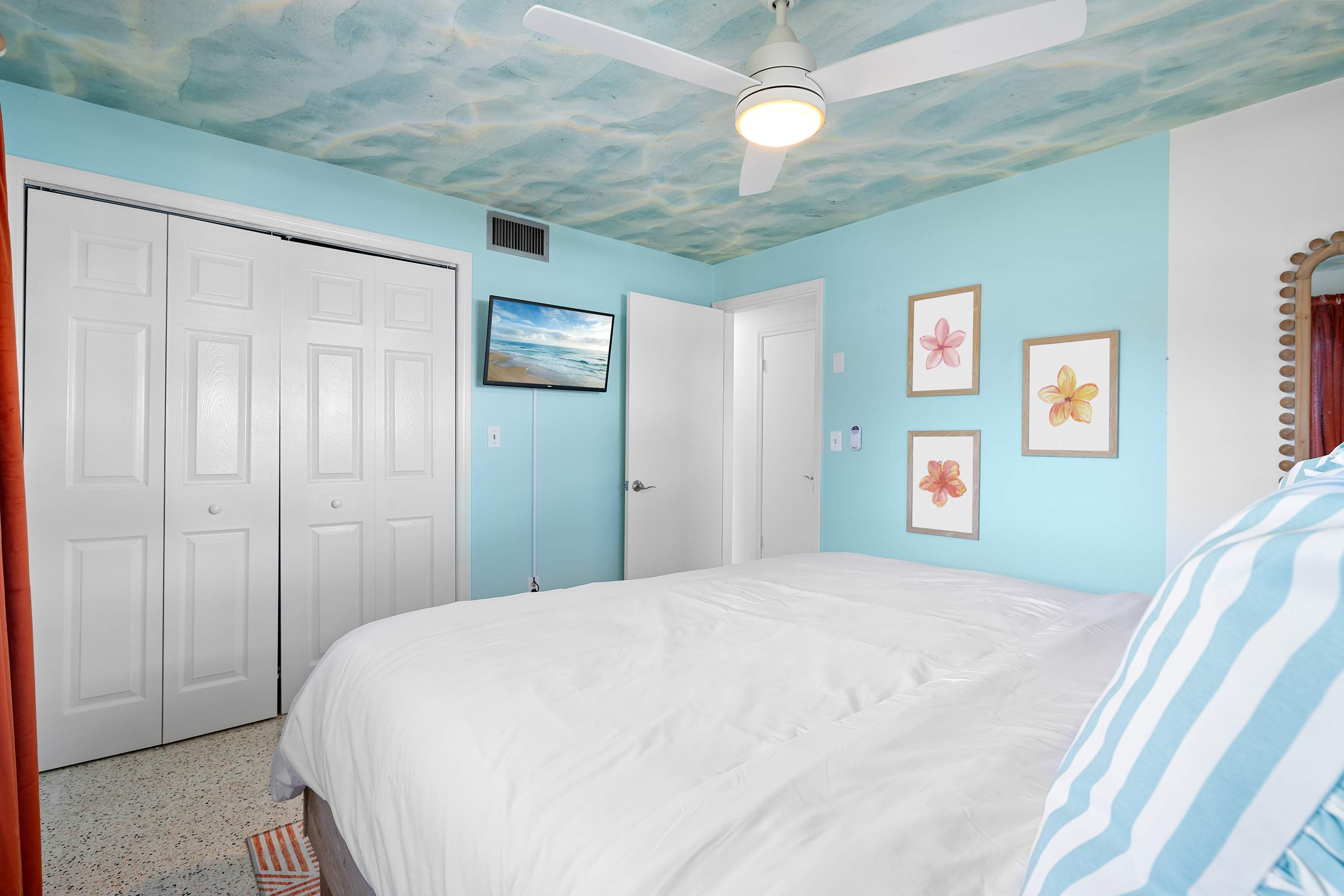 Serene bedroom w/ light decor and a peaceful, uncluttered vibe.