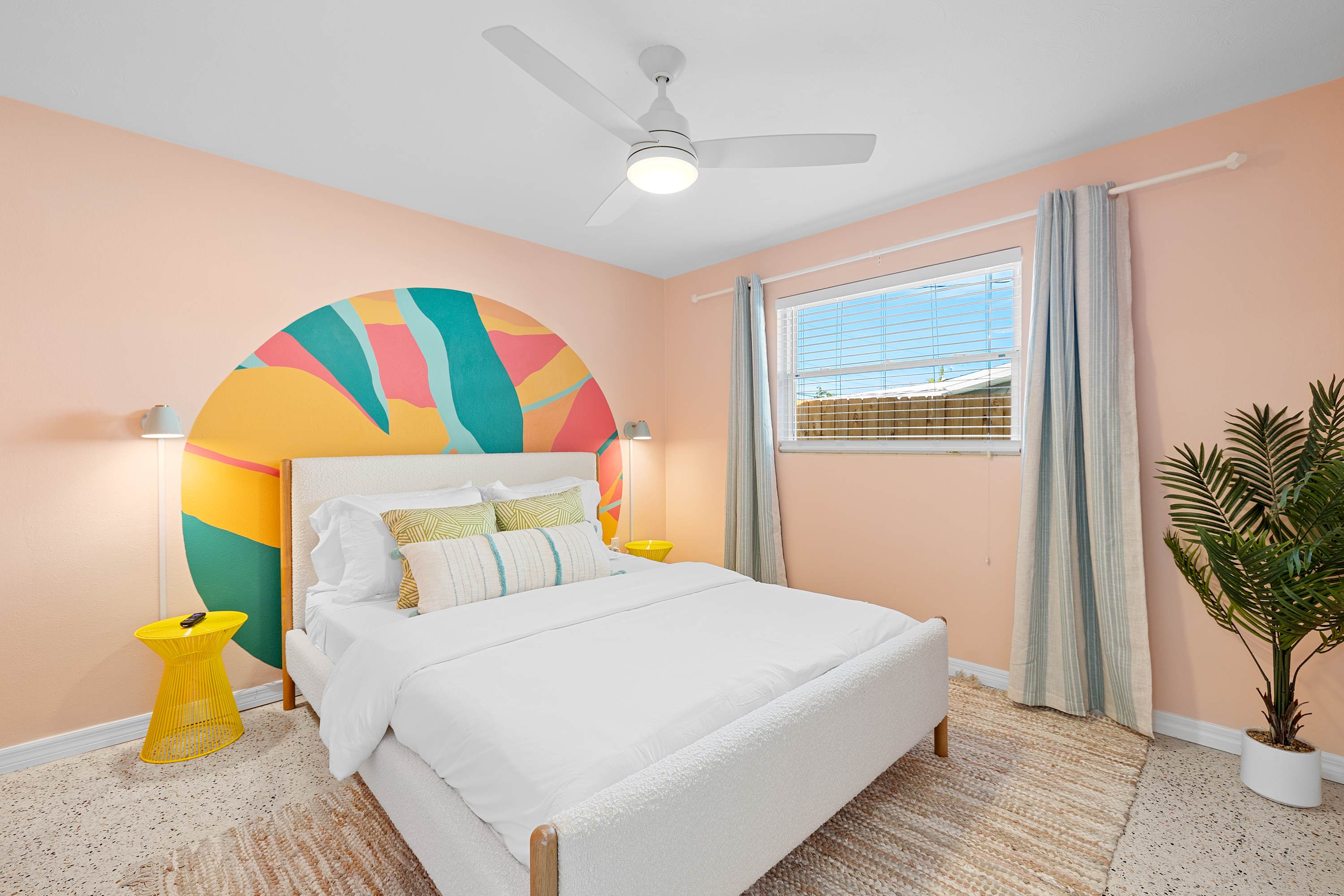 Cheerful bedroom w/ rainbow accents and a light, happy atmosphere.
