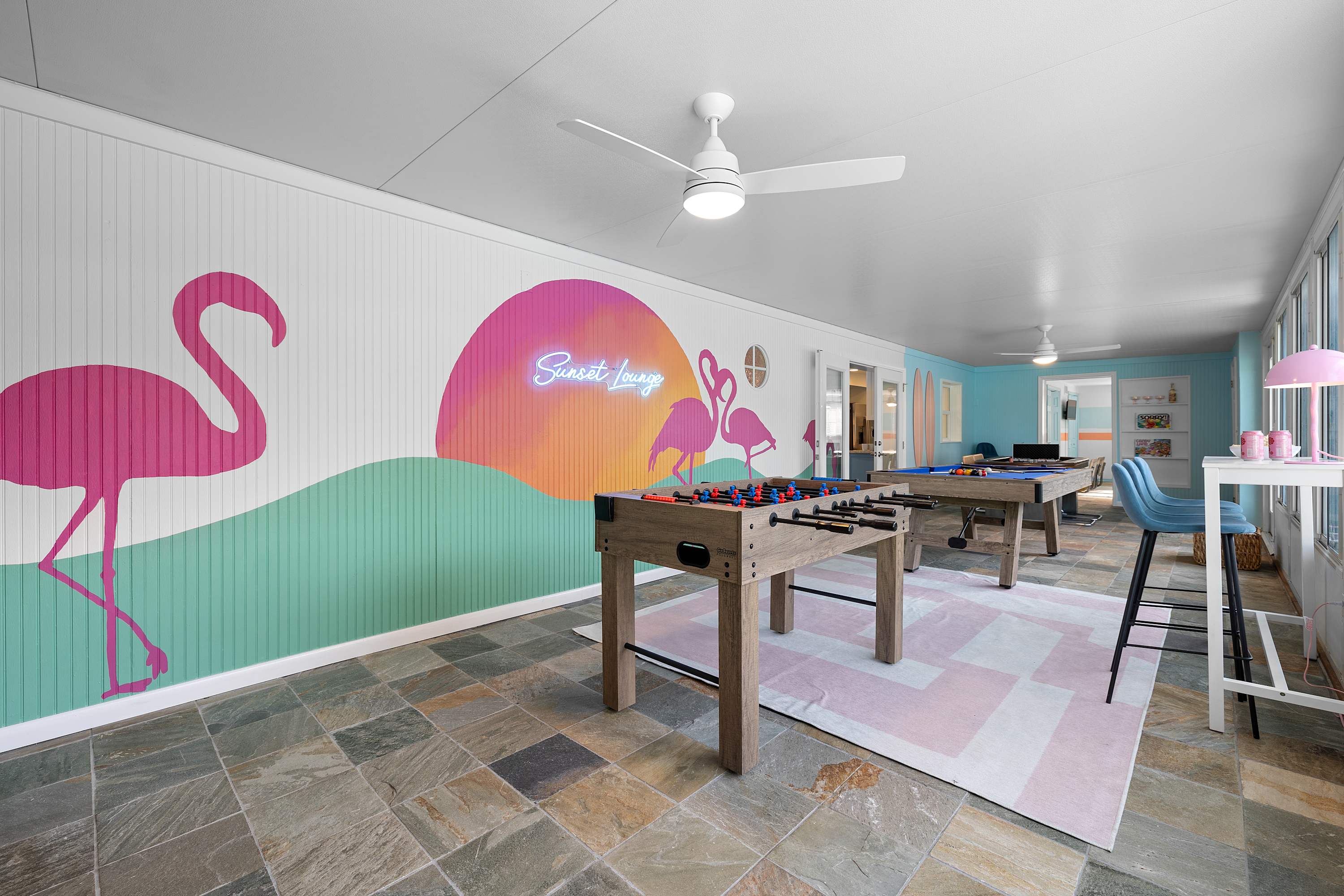 Creative game room w/ vibrant wall art and space to gather.