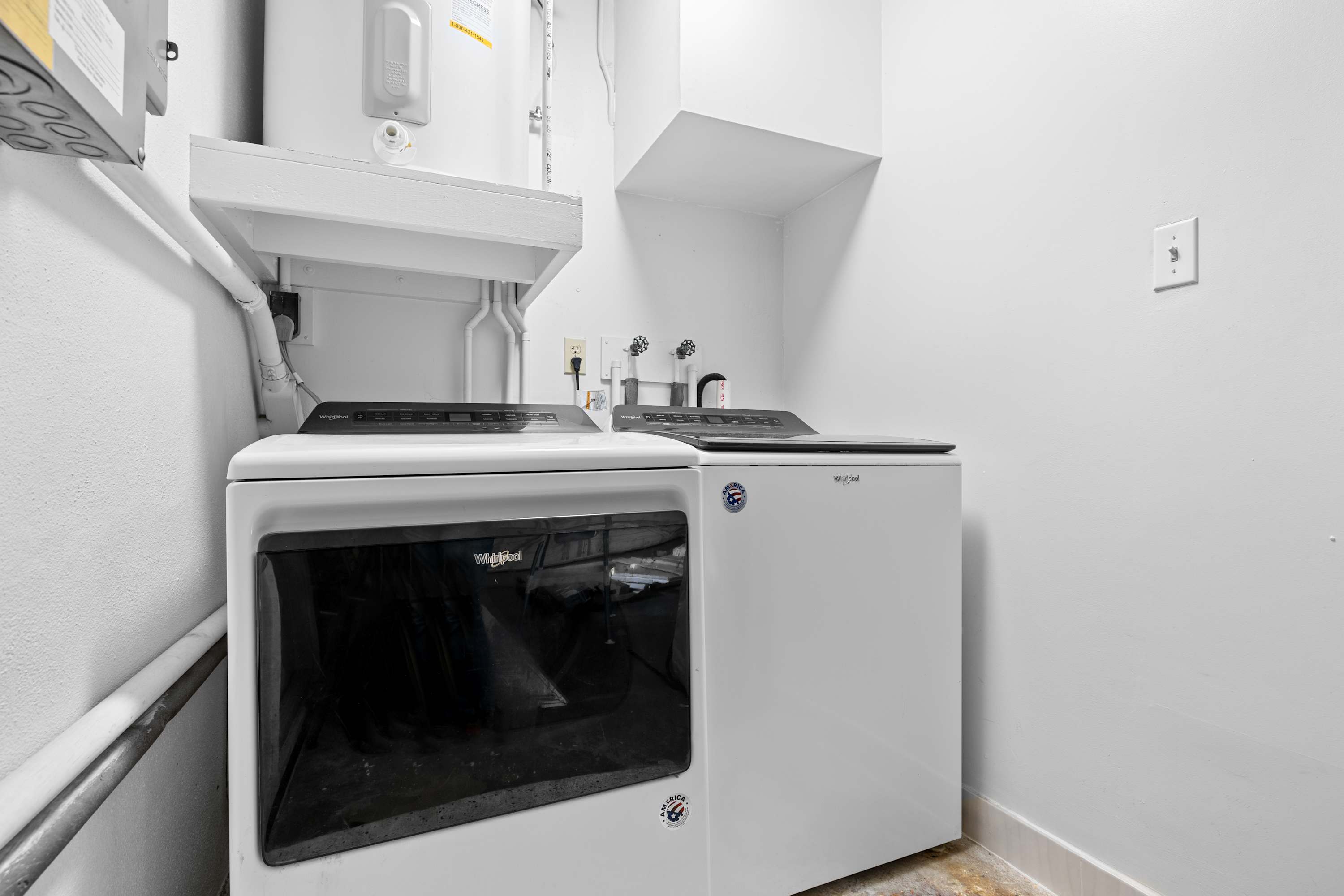 Laundry area w/ washer & dryer neatly tucked away.