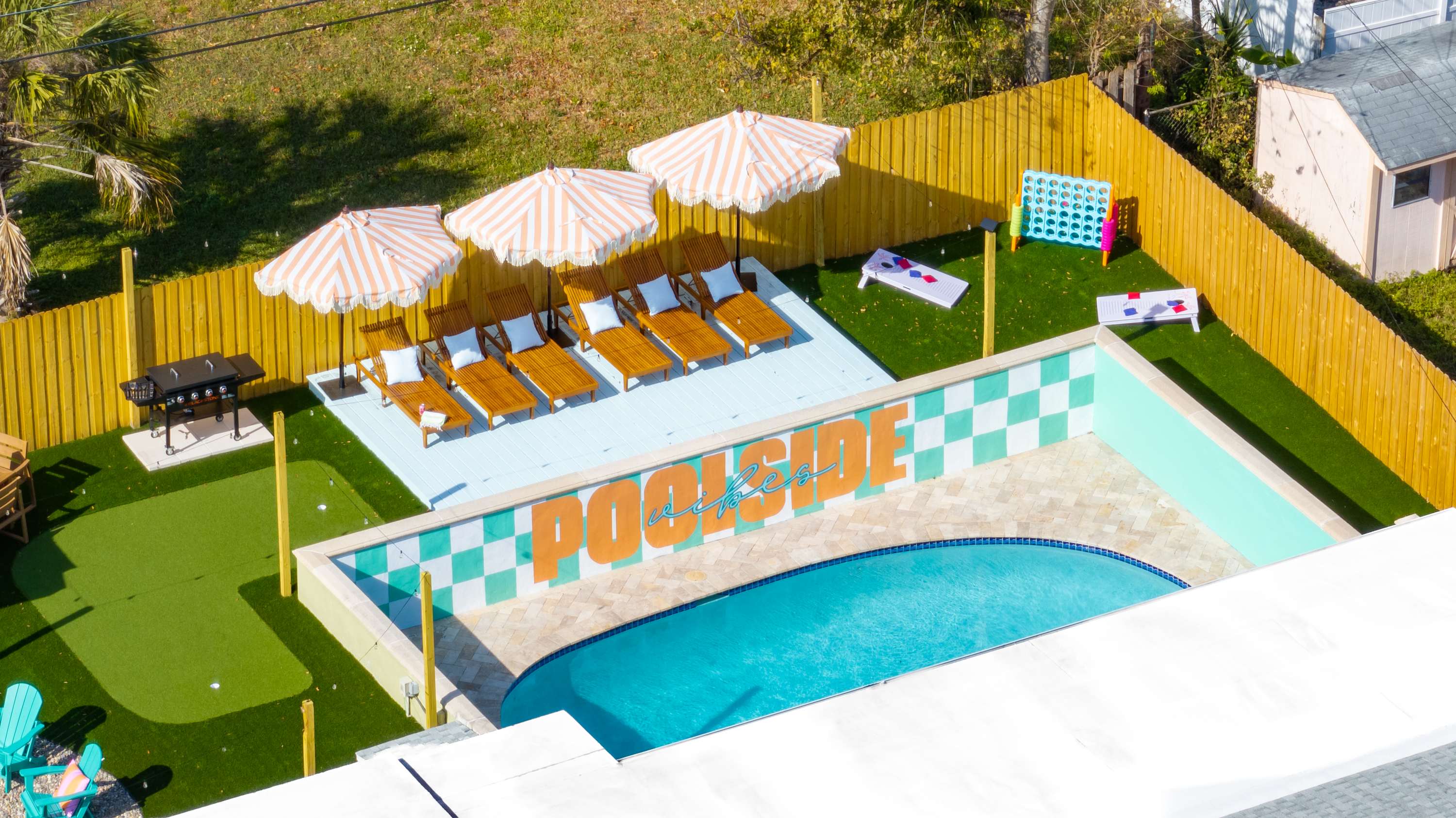 Aerial view highlighting the home’s outdoor layout and pool area.