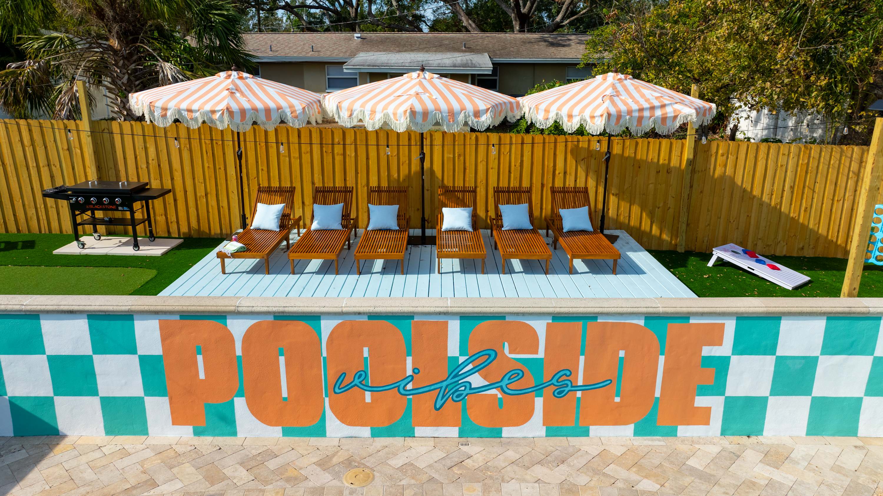 Resort-style pool area w/ shaded seating and a relaxed vacation feel.