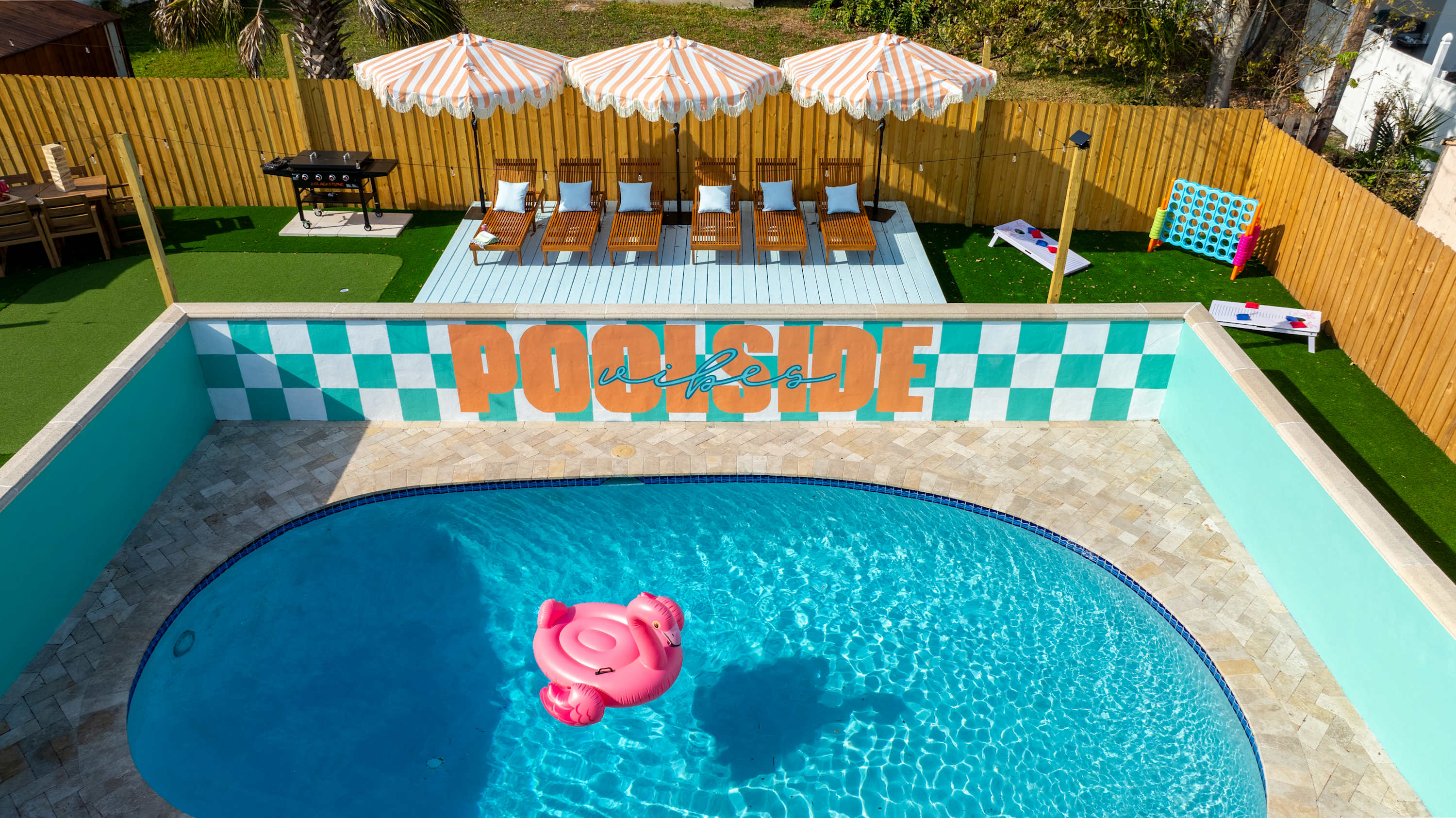 Poolside view w/ loungers and colorful details that pop in the sun.