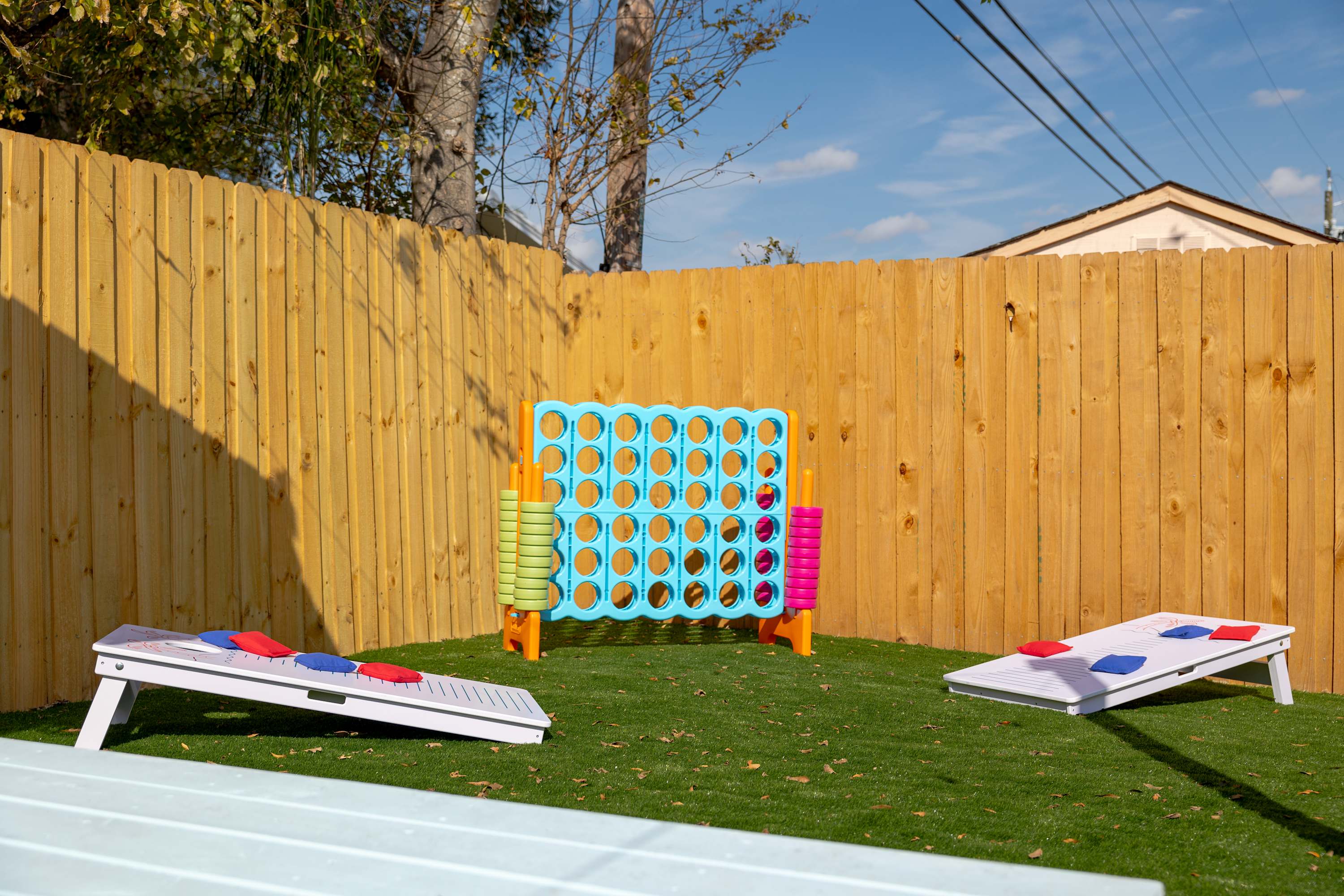 Yard space w/ games and seating, made for playful afternoons outside.