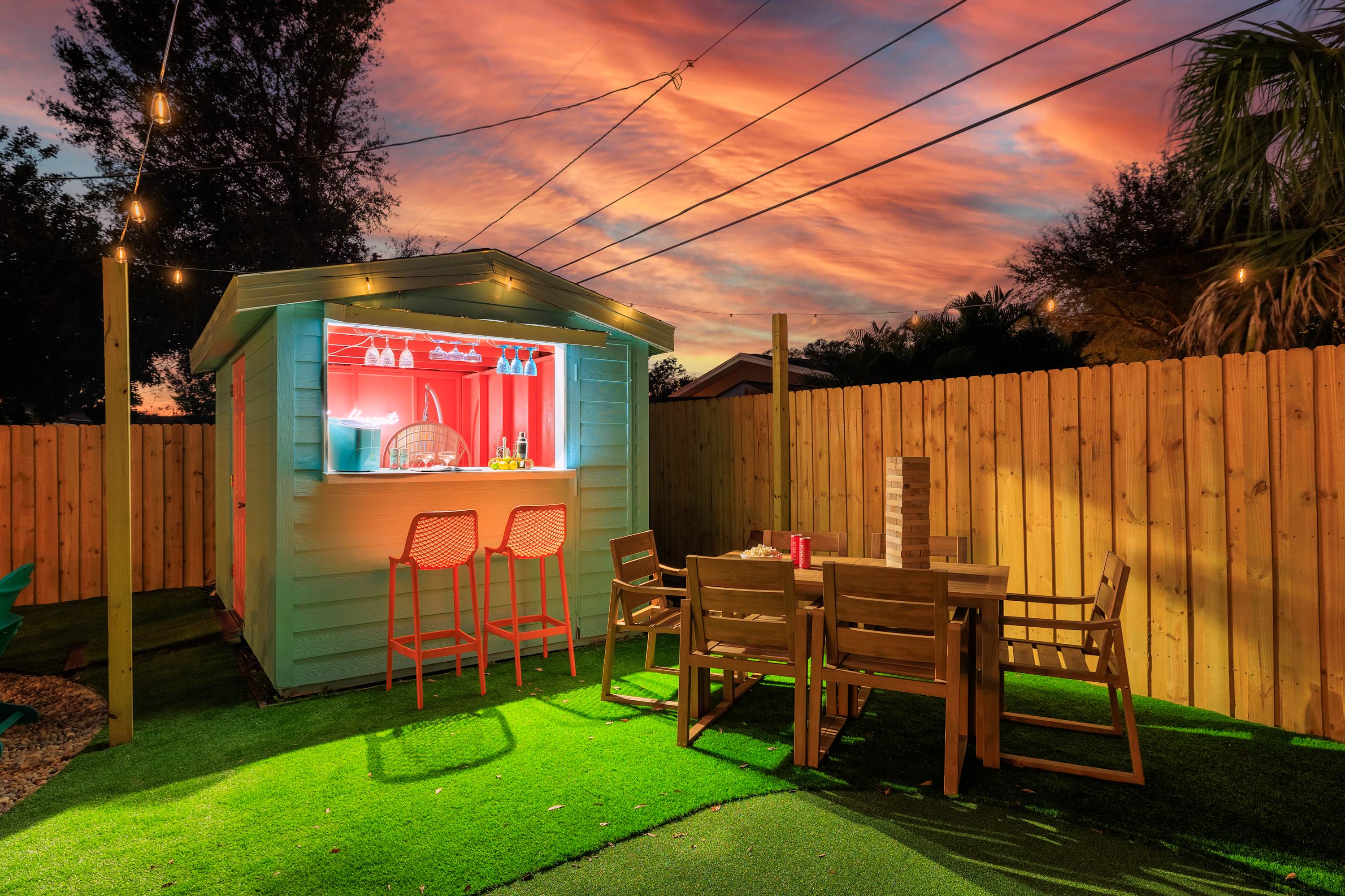 Backyard lawn w/ seating, great for sunsets, games, or evening hangs.