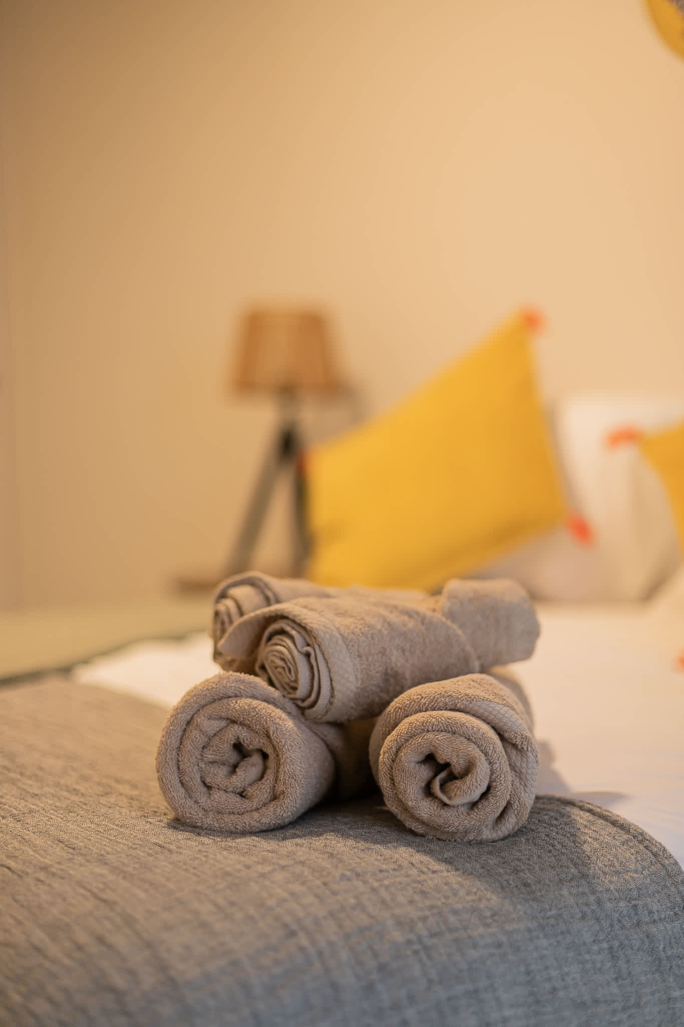 Relax in style with cozy bedding and vibrant accents in this inviting space.