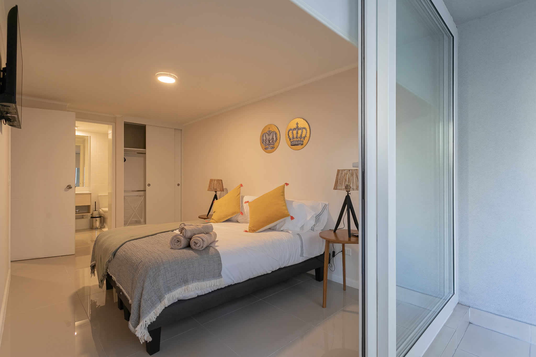 Unwind in this cozy bedroom with elegant decor and direct access to a serene outdoor space.