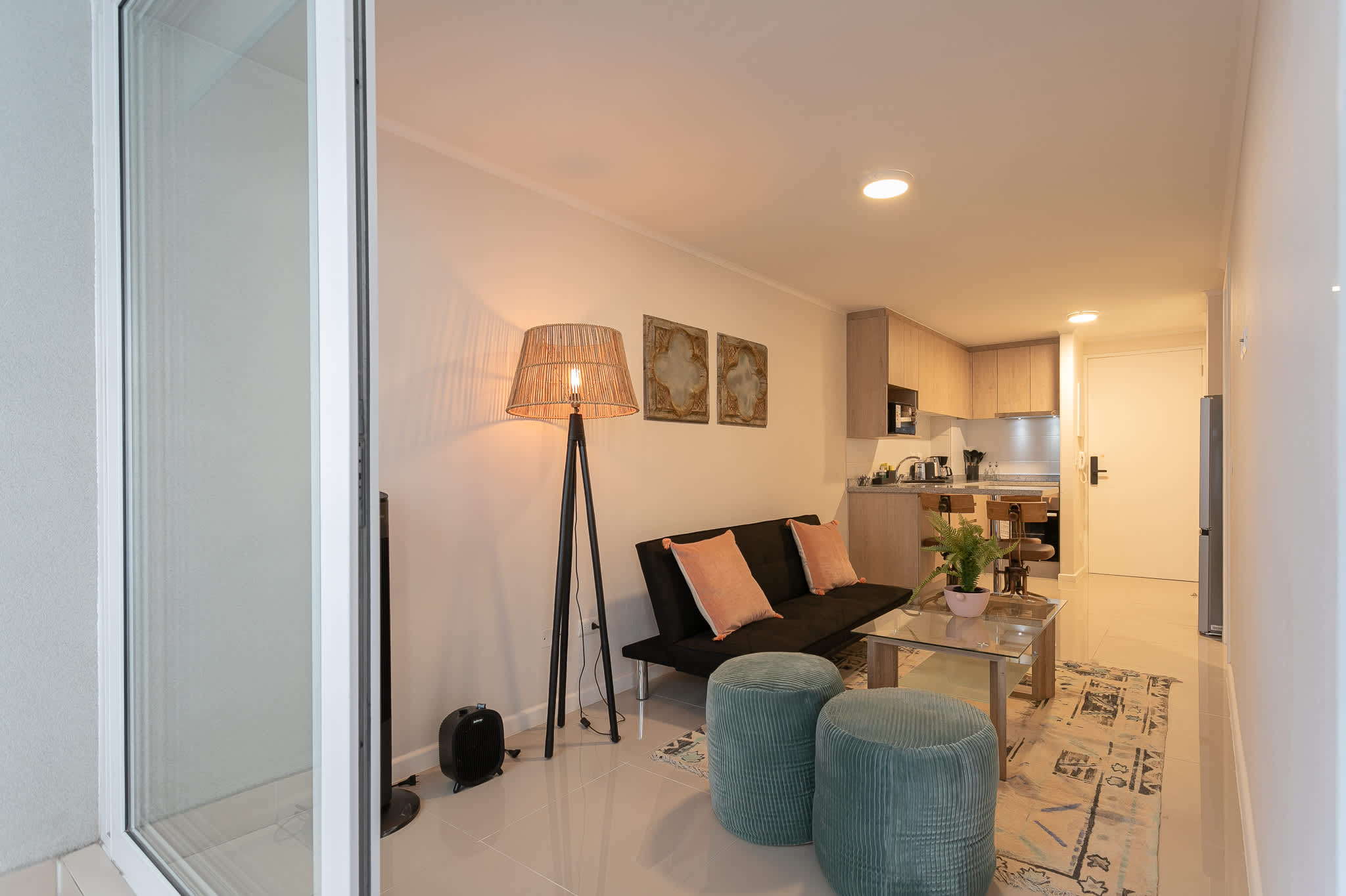 Charming living area with modern decor and a functional kitchen, ideal for unwinding after exploring the city.