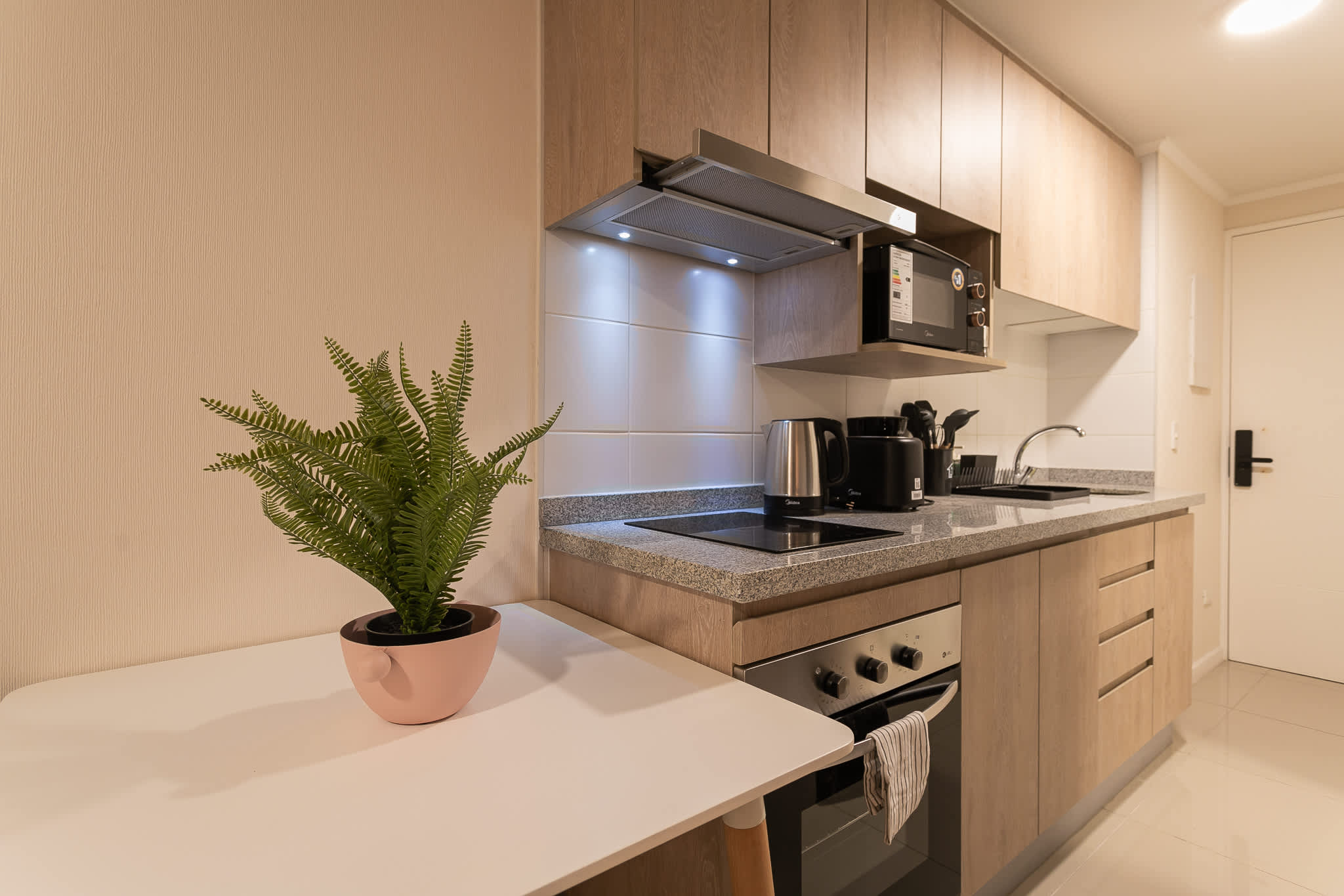 Modern kitchen with sleek appliances and cozy dining space, perfect for culinary adventures.