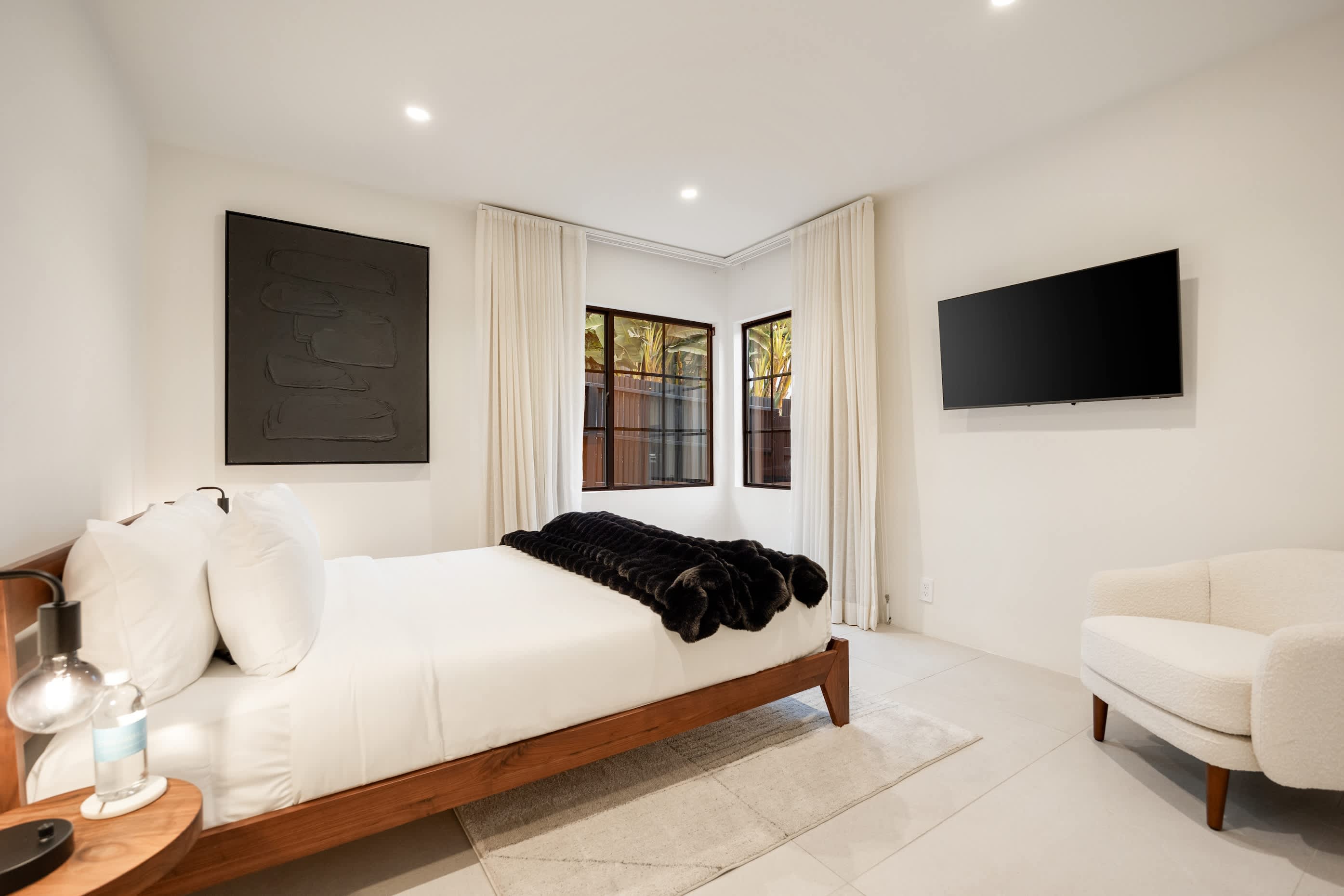 Every element, from the tailored bedding to the soft pendant glow, is designed for relaxation.