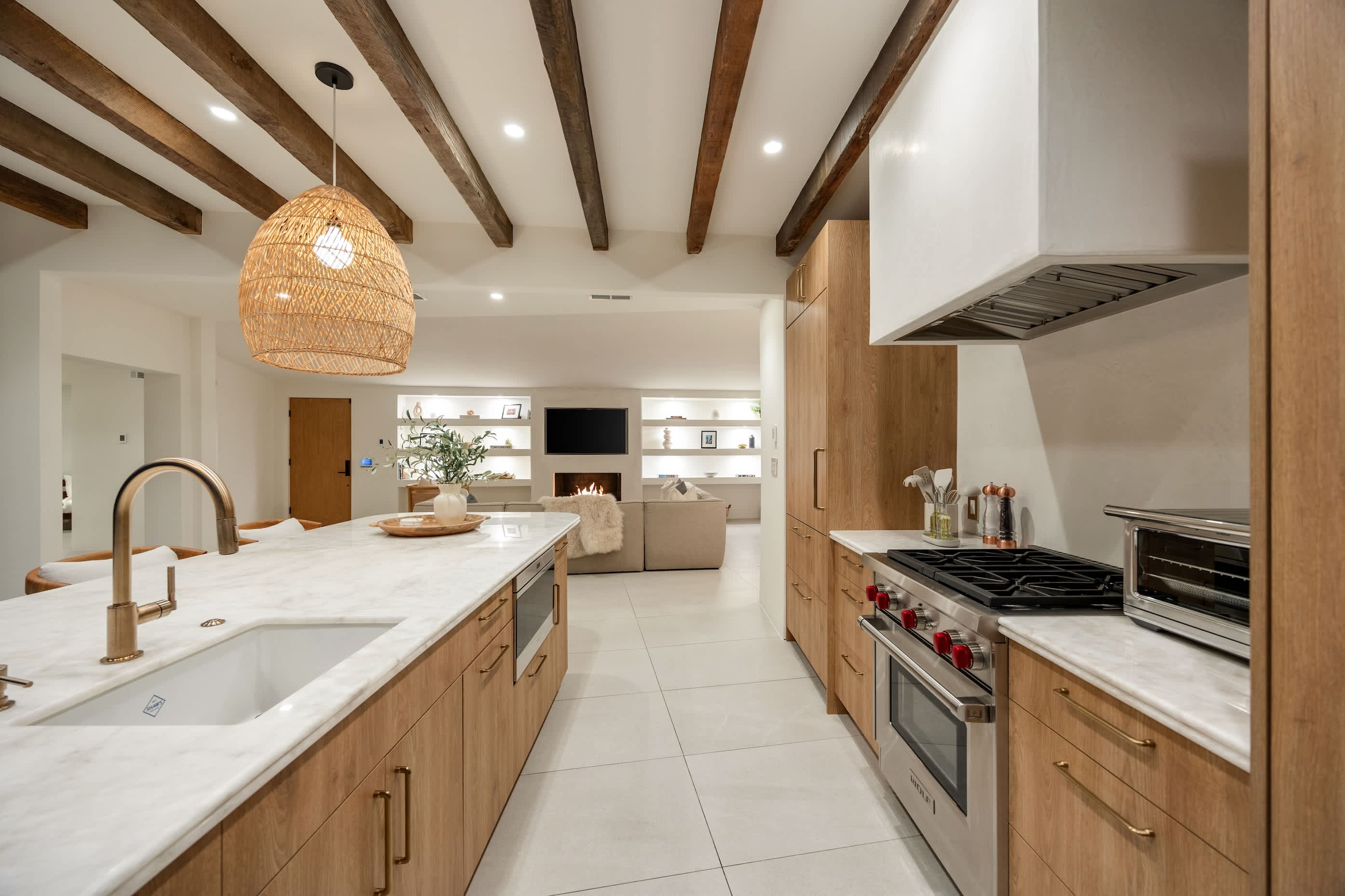 A spacious island with a brass faucet is perfect for prepping, serving, or gathering.