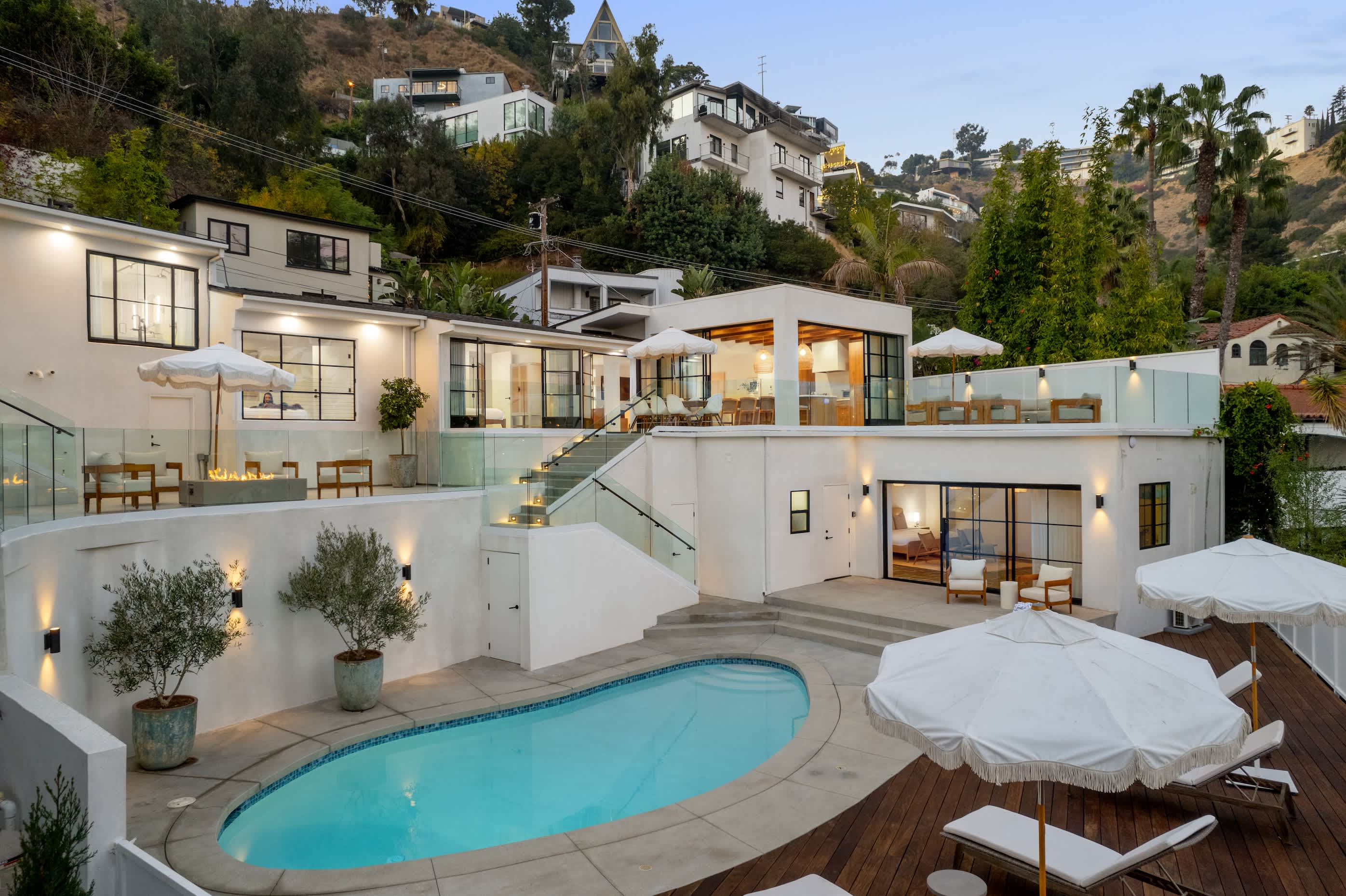 Where multi-level terraces, a glowing fire pit, and a sparkling pool redefine hillside living.