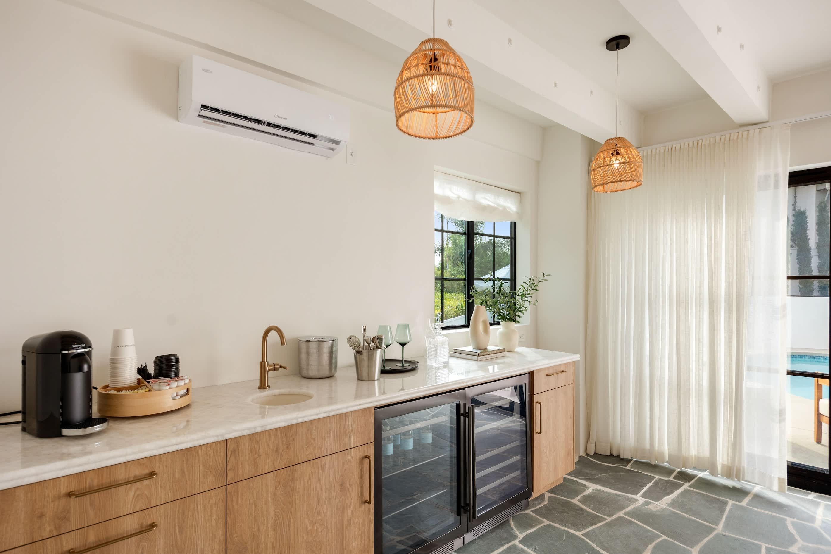 Equipped with dual wine fridges and a sleek brass faucet for ultimate convenience.