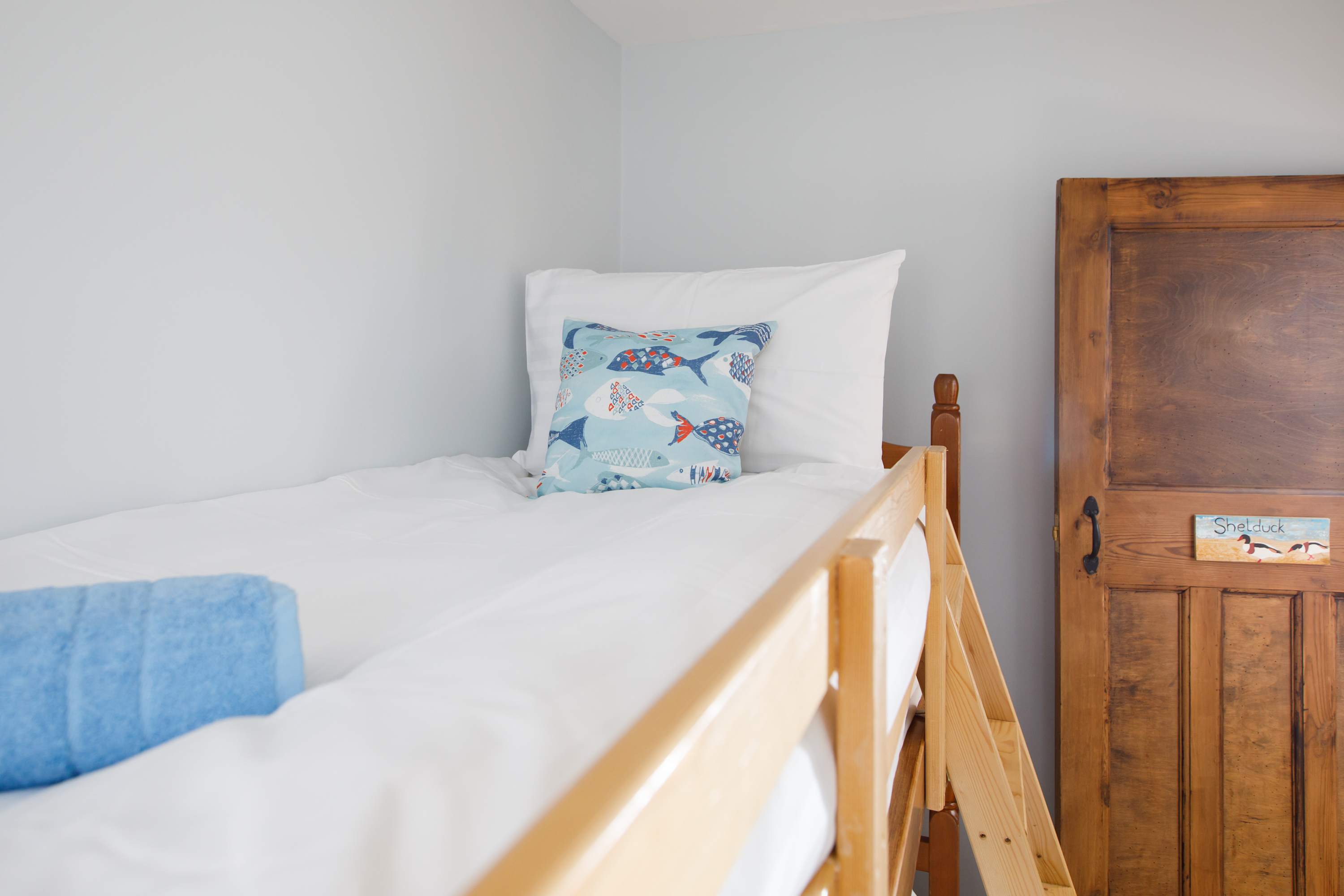 Which child is going to occupy the top bunk?