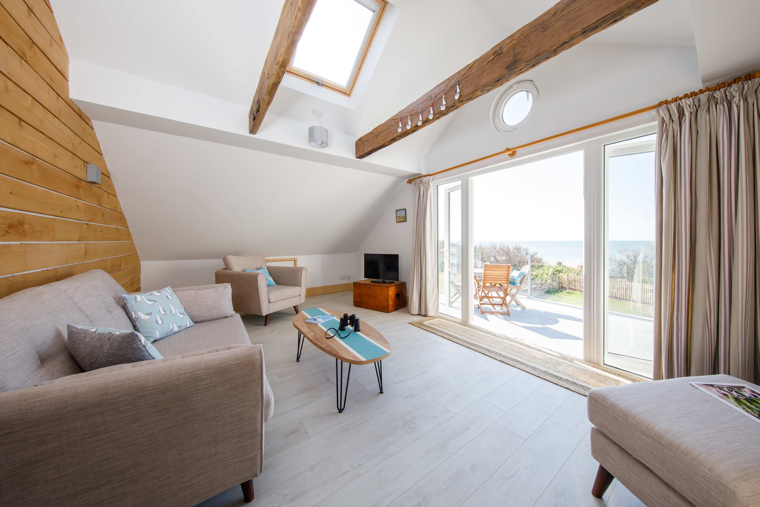 1st-floor living room offers a comfortable area from which you can gaze directly at sea