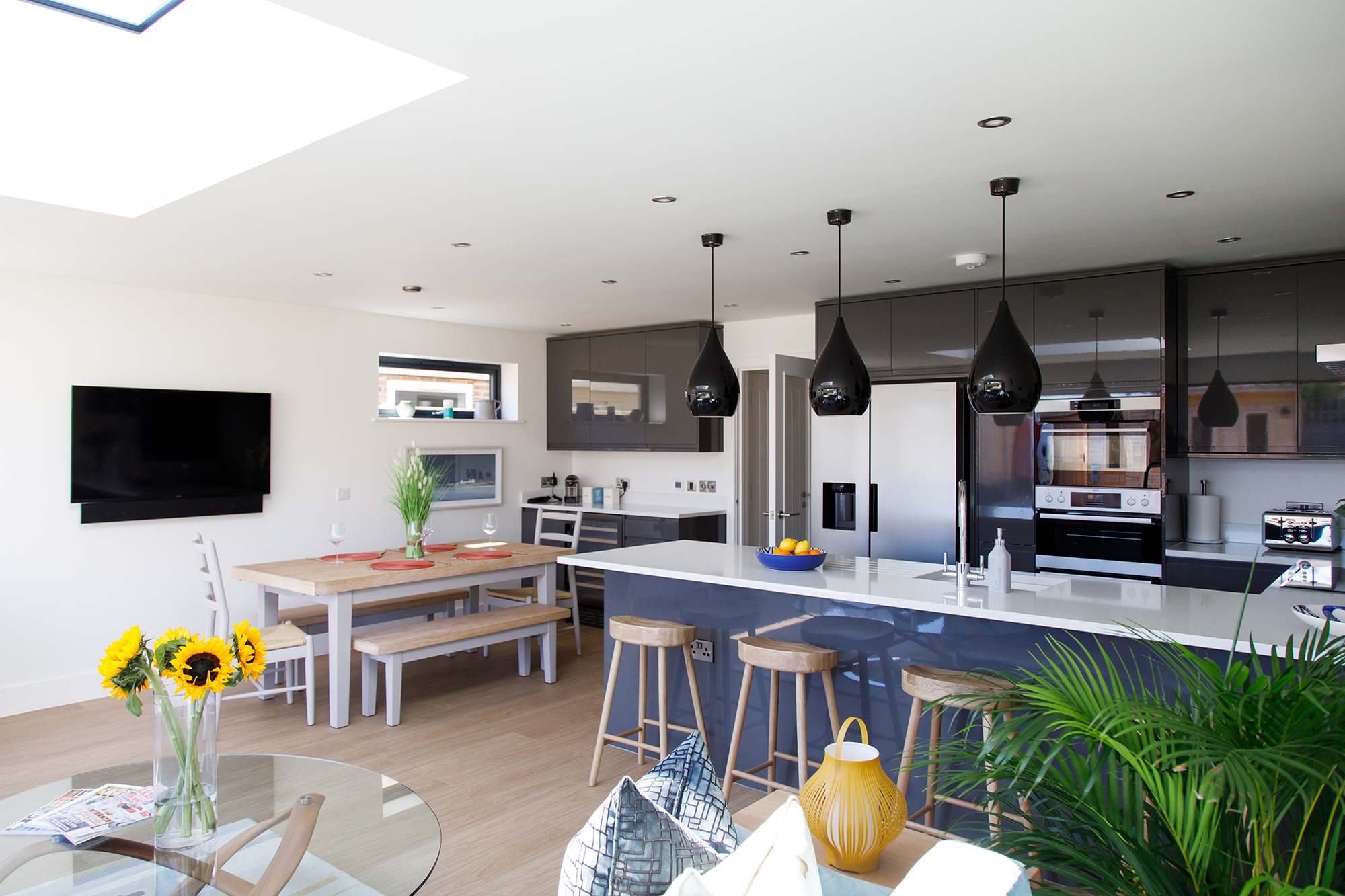 The open plan living and dining space is contemporary and modern in style.