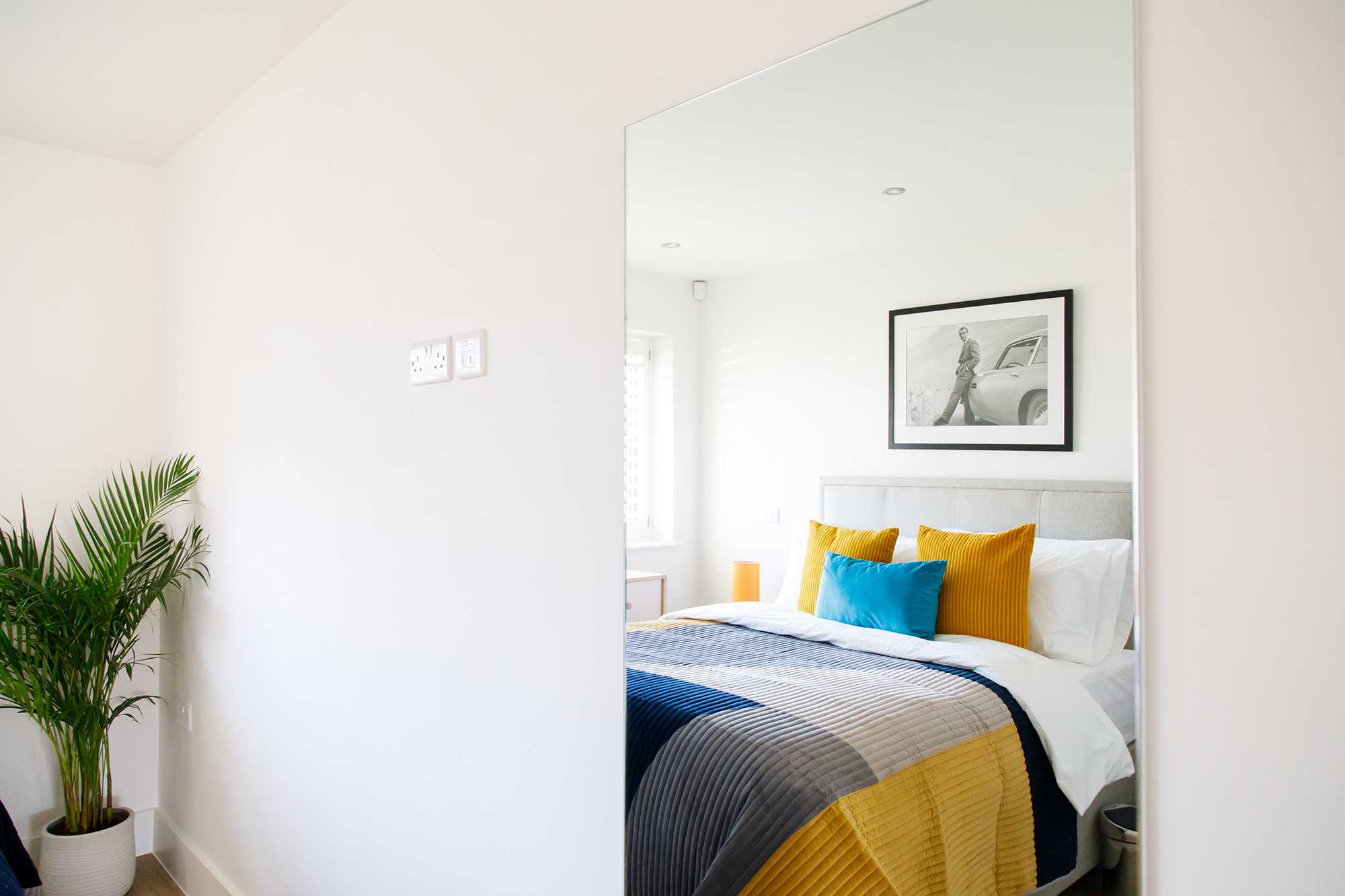 The ground floor king bedroom is beautifully decorated with pops of colour.