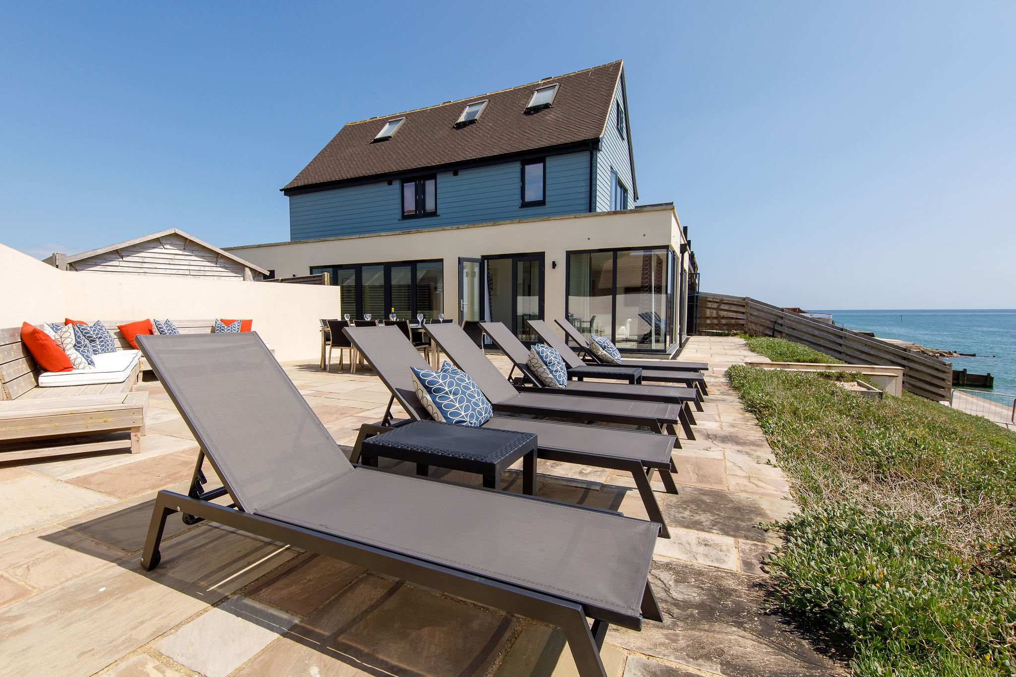 The patio has comfy corner seating, dining furniture and sun loungers.