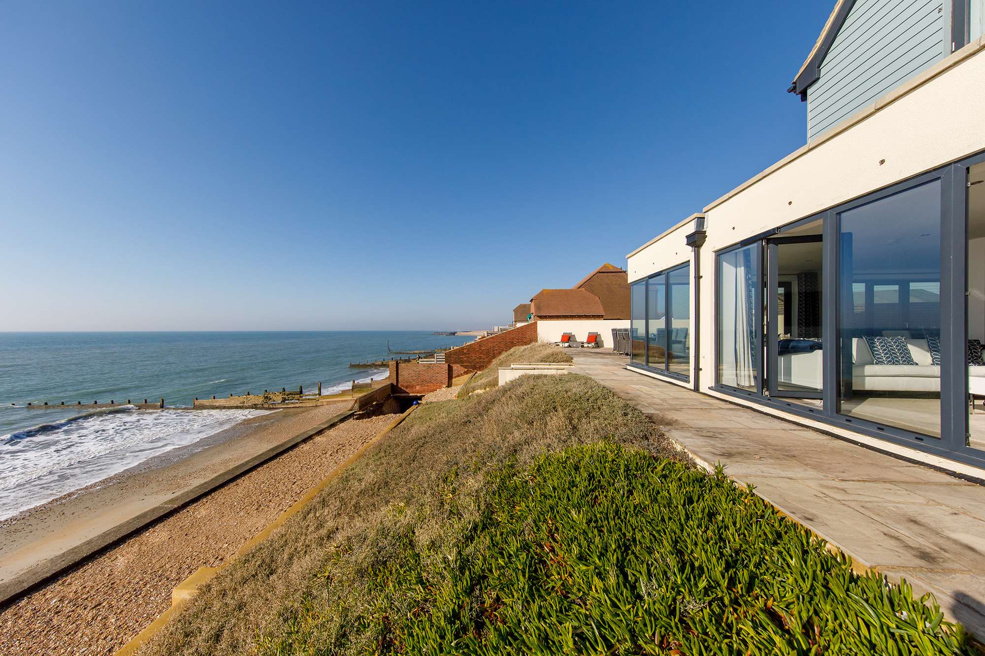 Open the living room doors and let the warm sea air drift in.