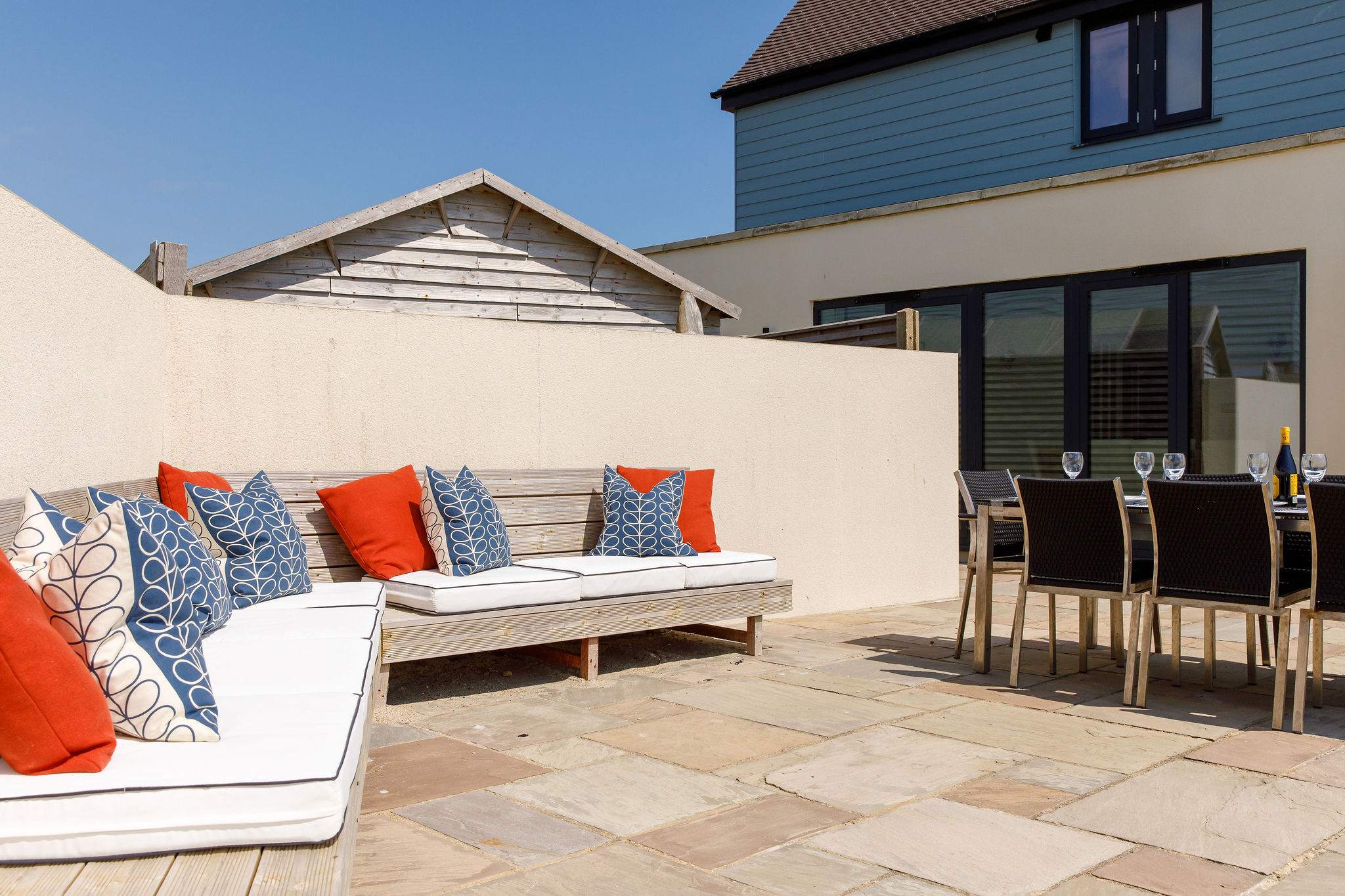 The comfy corner seating at the rear of the home looks out to sea.
