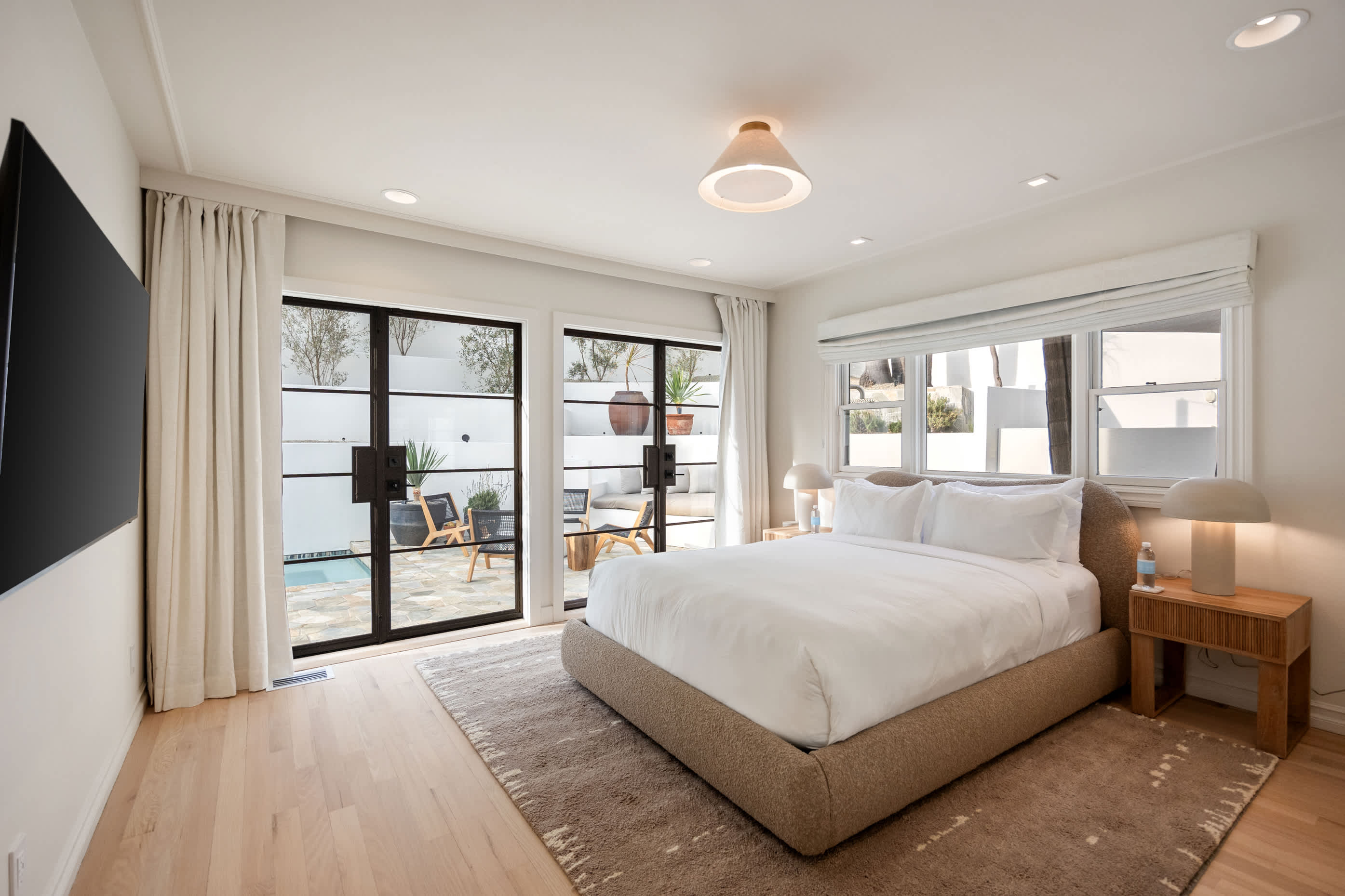 Indulge in luxury with a tranquil bedroom offering garden views and elegant finishes.