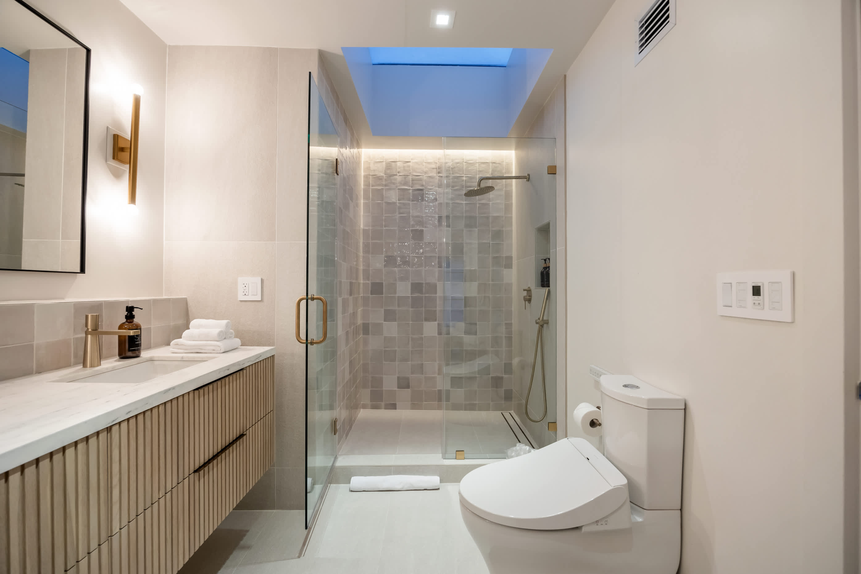Step into indulgence with a rain shower and modern details.