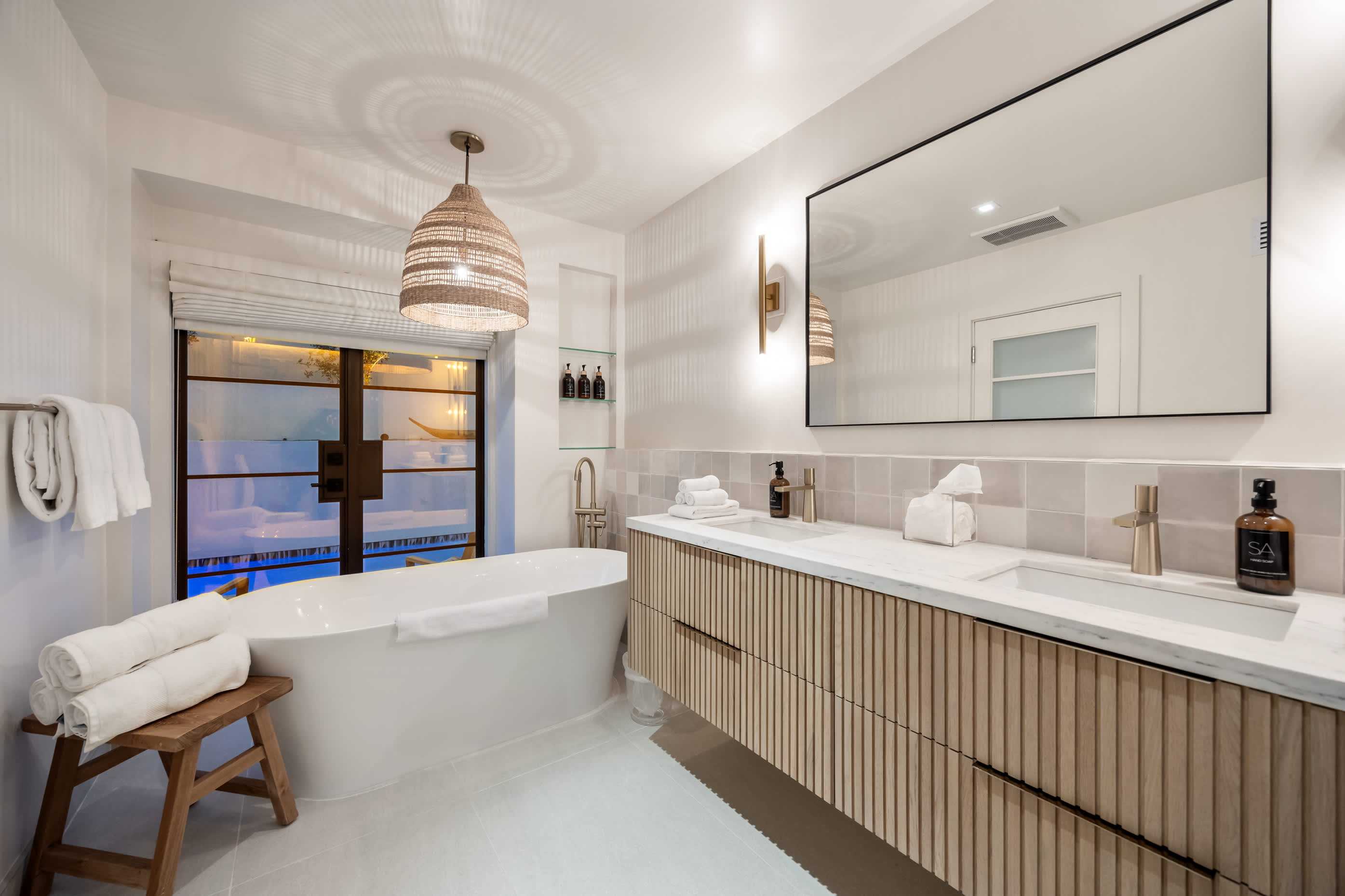 Soak in elegance with a freestanding tub and designer lighting.