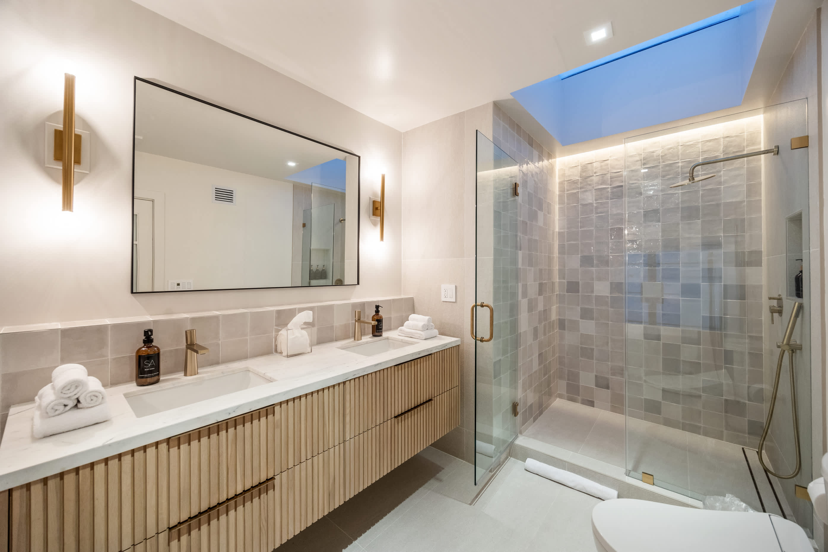 Soak in elegance with double vanities and serene lighting.
