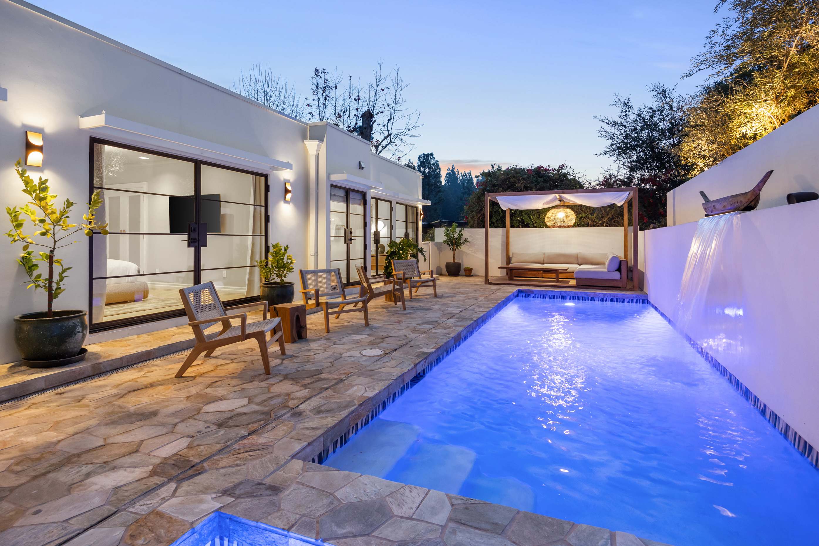 Your evening sanctuary awaits—sparkling pool, warm lighting, and endless charm.