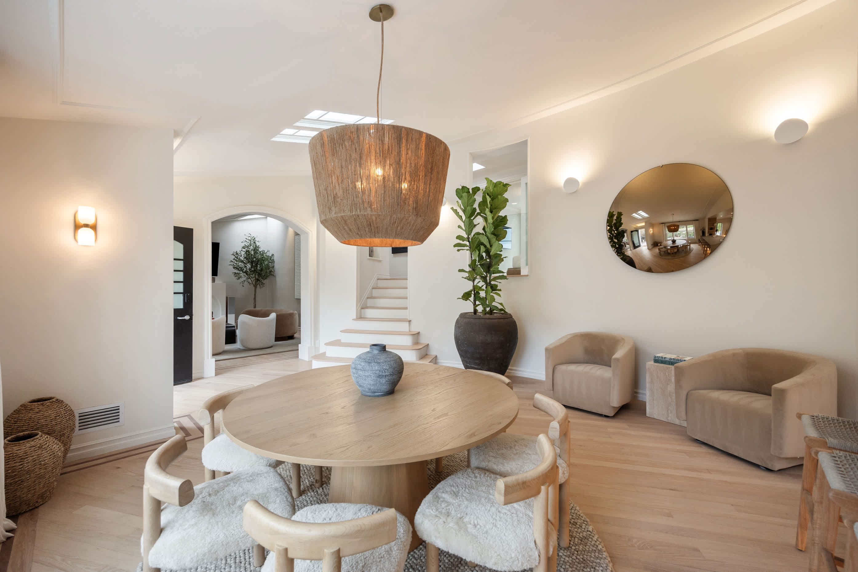 Dine beneath the striking glow of a woven pendant, surrounded by natural textures and warm tones.
