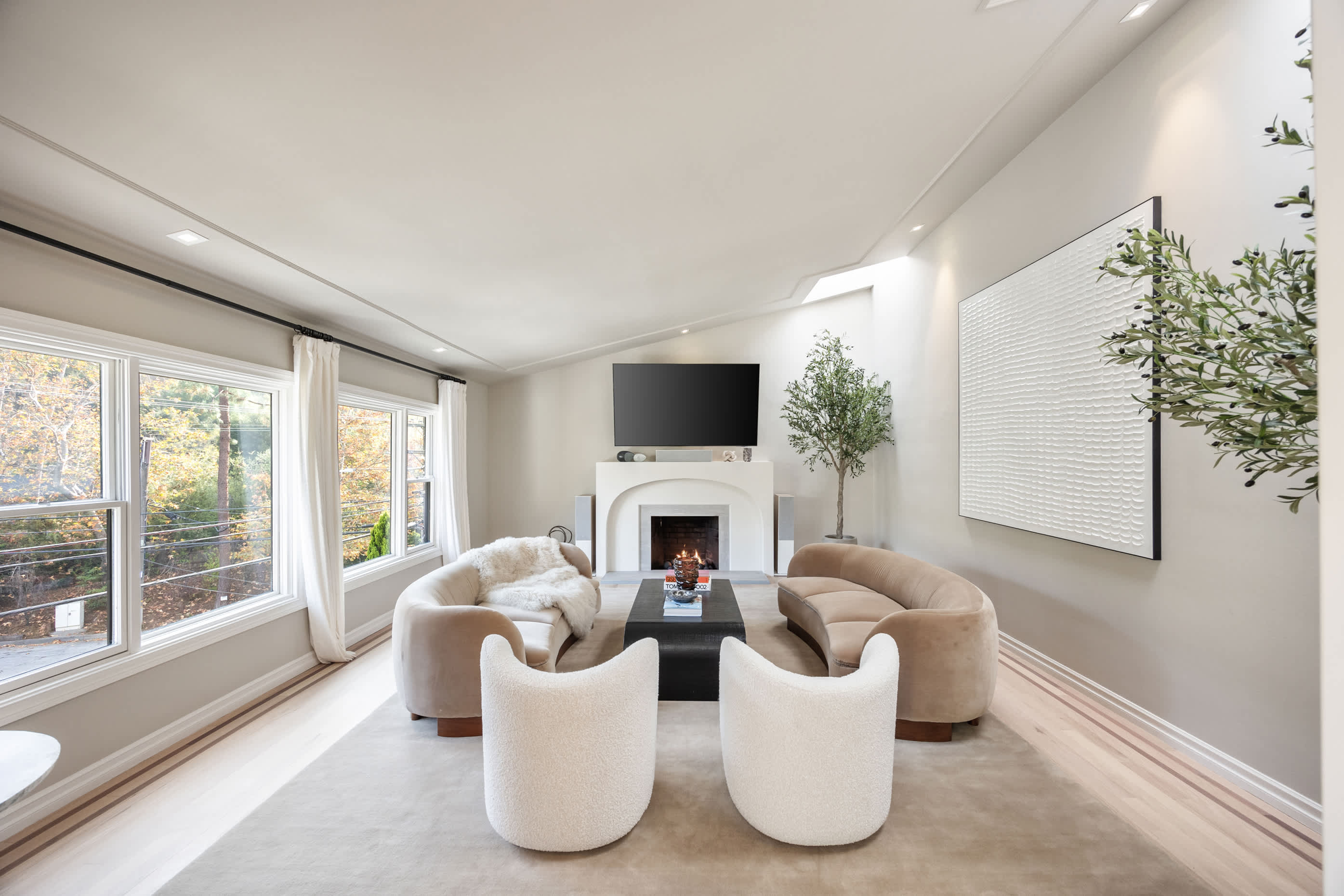 Find timeless charm in the spacious living room, with soft sunlight and a crackling fireplace.