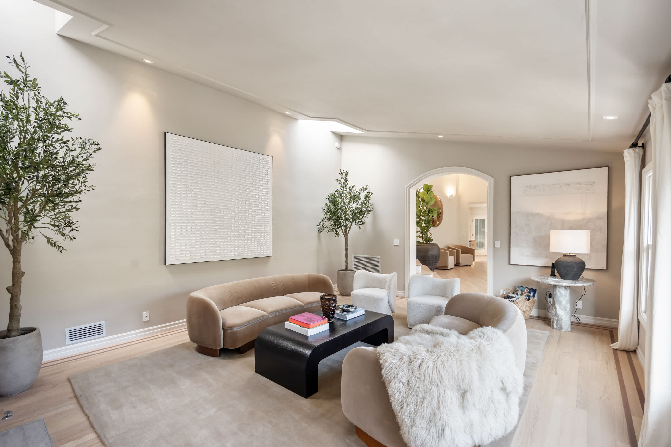 Relax in style with plush seating, curated artwork, and soft natural tones.