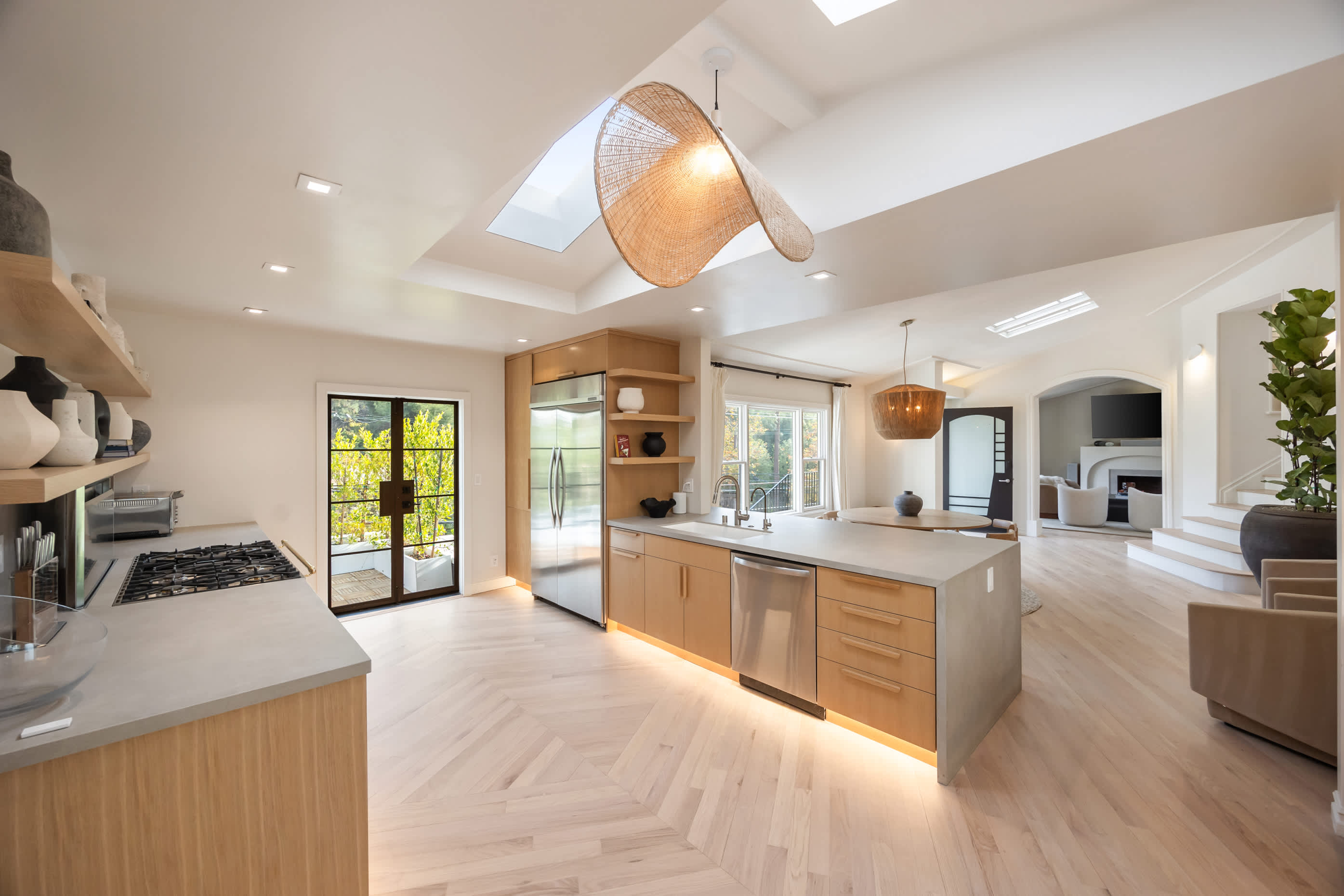 Expansive kitchen featuring a central island, high-end appliances, and skylit elegance.