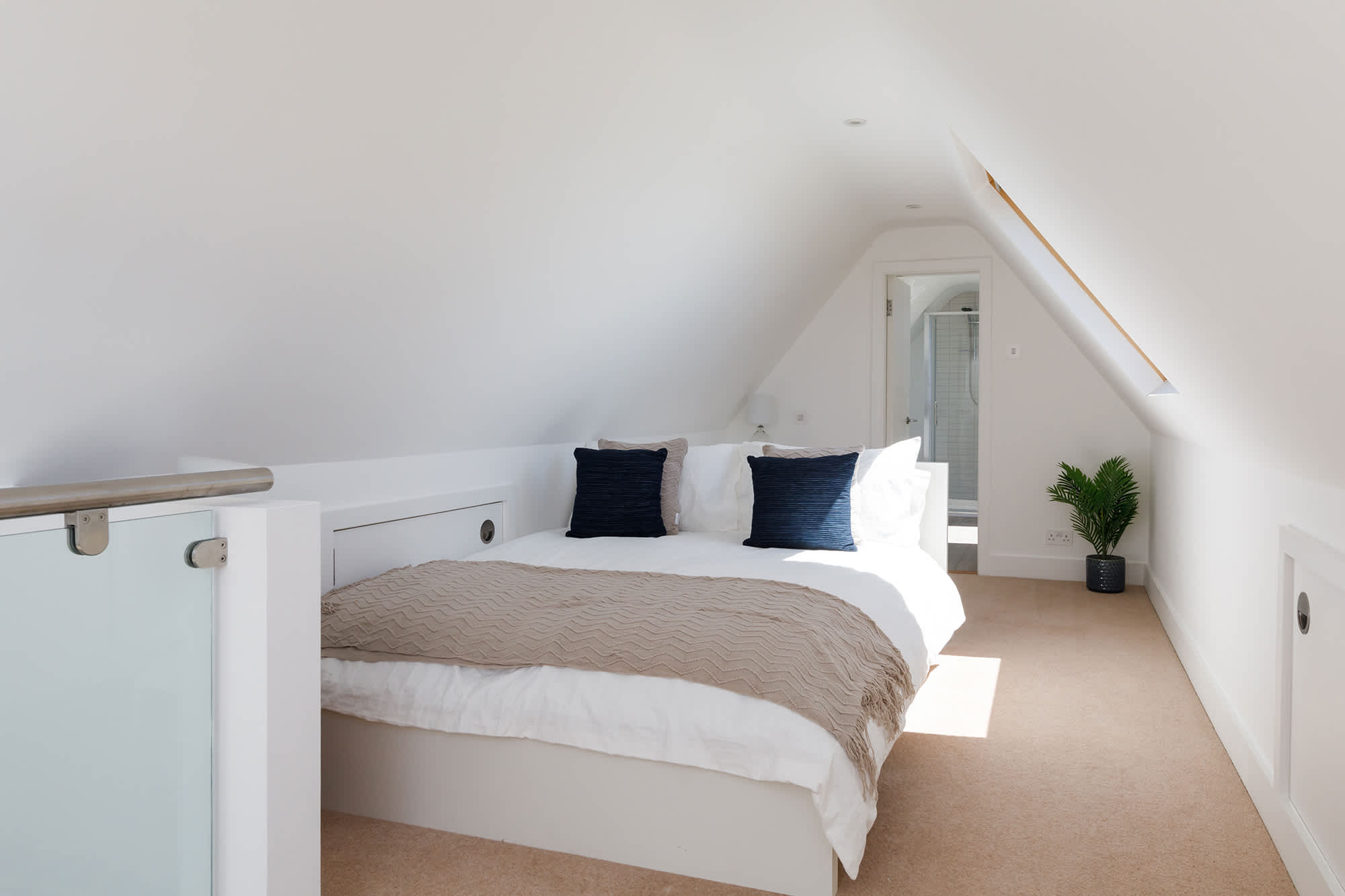 Sun-soaked loft bedroom with another ensuite bathroom