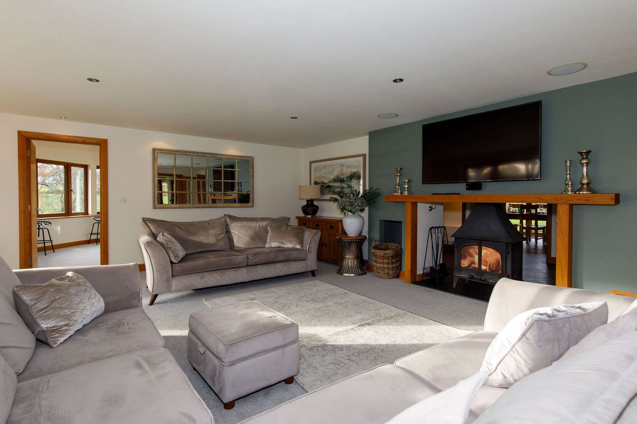 A spacious lounge with wood burner, large TV, river views and bifold doors onto the patio.