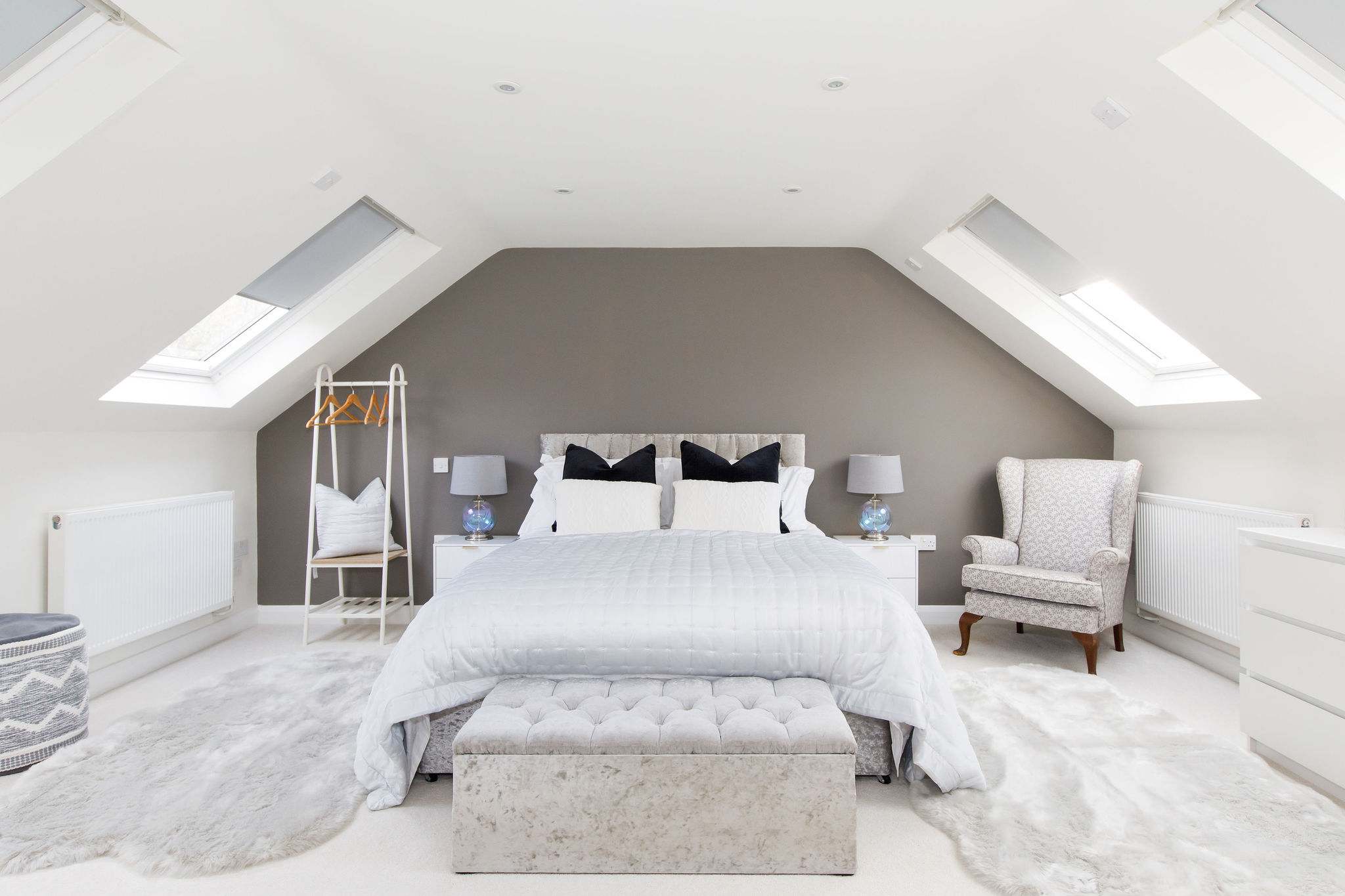 Discover a 6th bedroom with soft rugs underfoot and luxury pillows for sleepy heads.