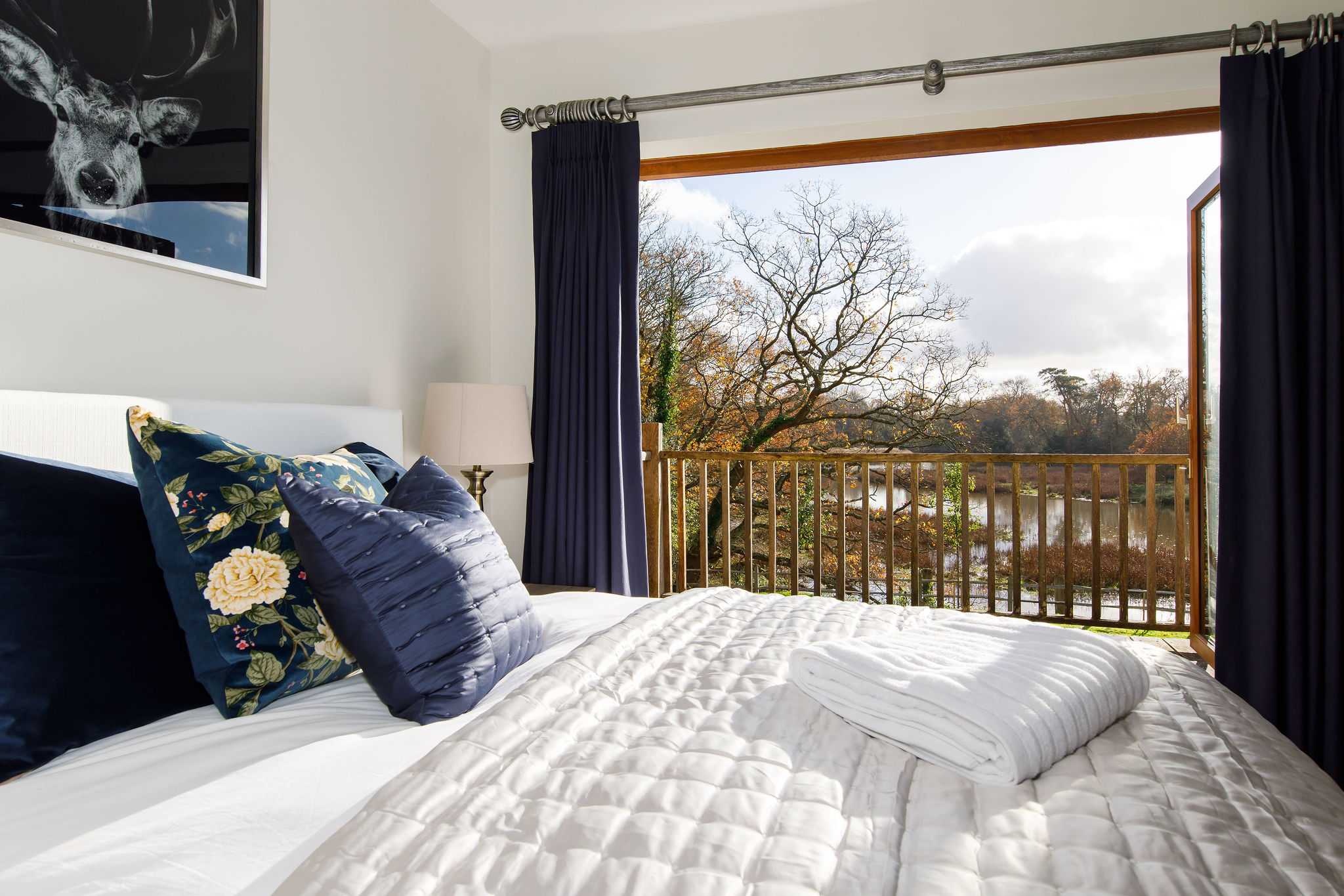 The master bedroom has balcony views to surrounding countryside and the river.