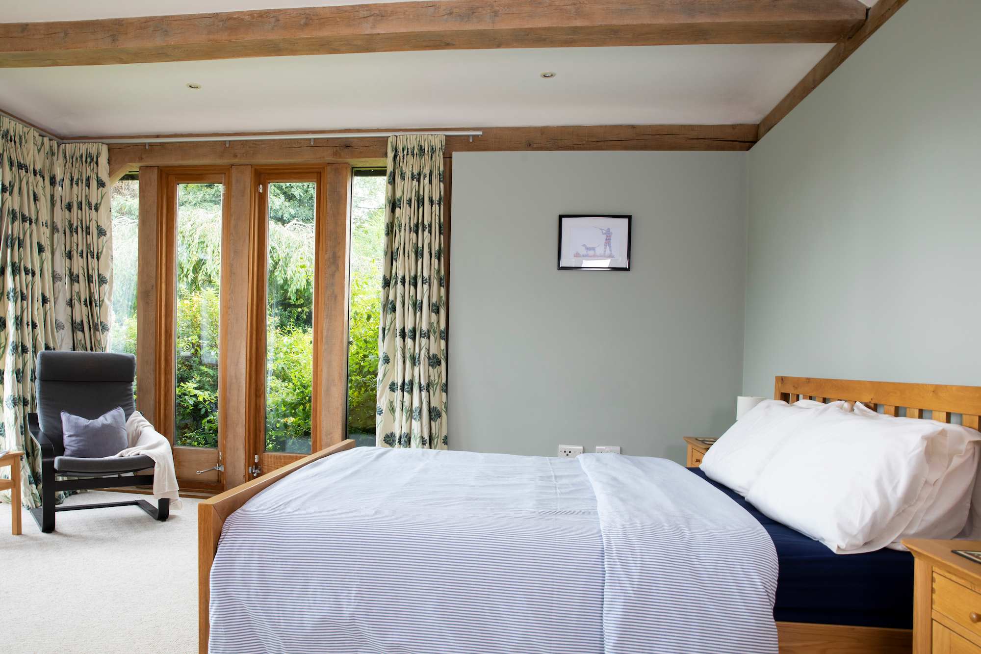 The master bedroom benefits from doors leading out to the garden.